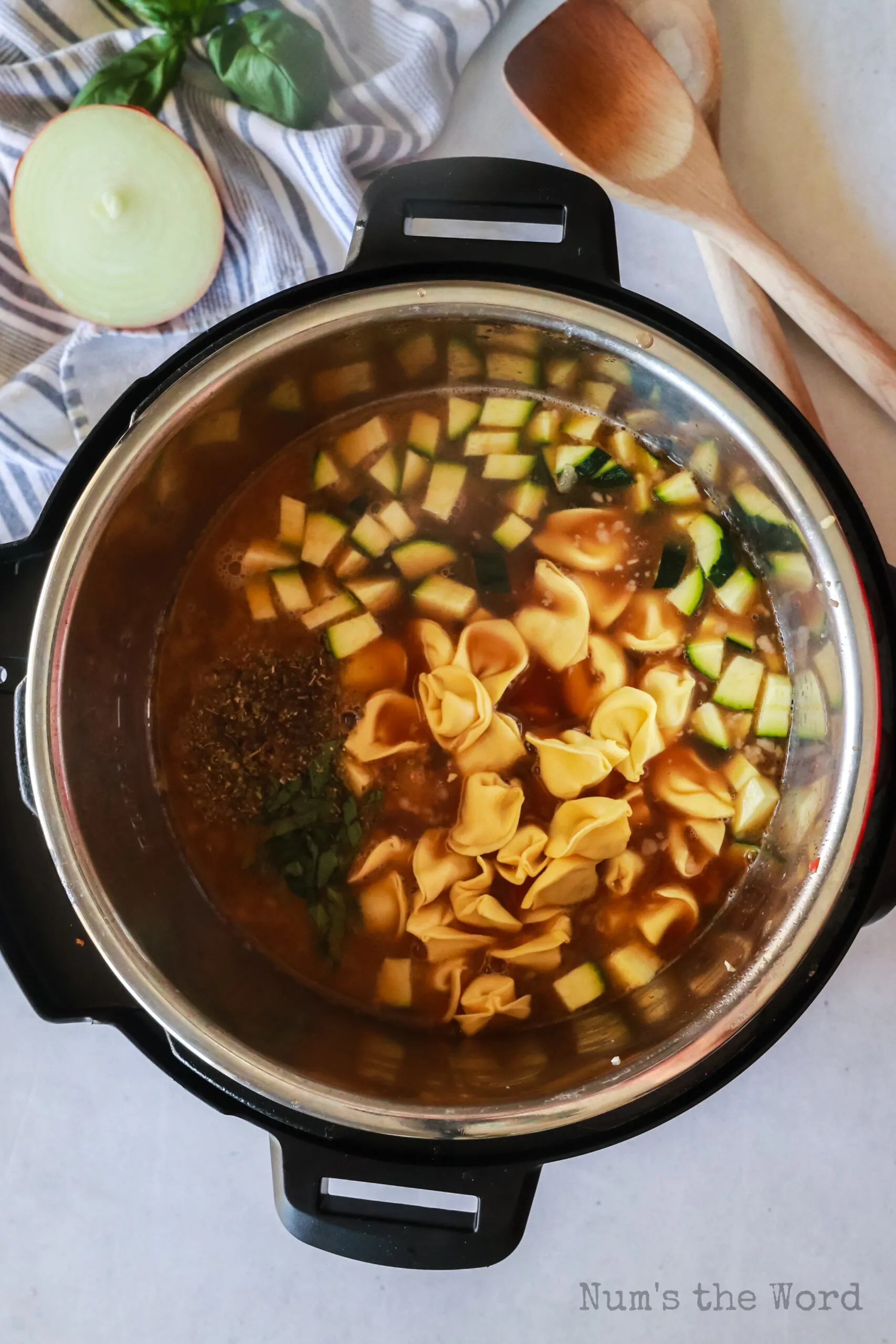 beef broth, tomatoes, carrots, basil, oregano, tomato sauce, zucchini and tortellini added to sausage