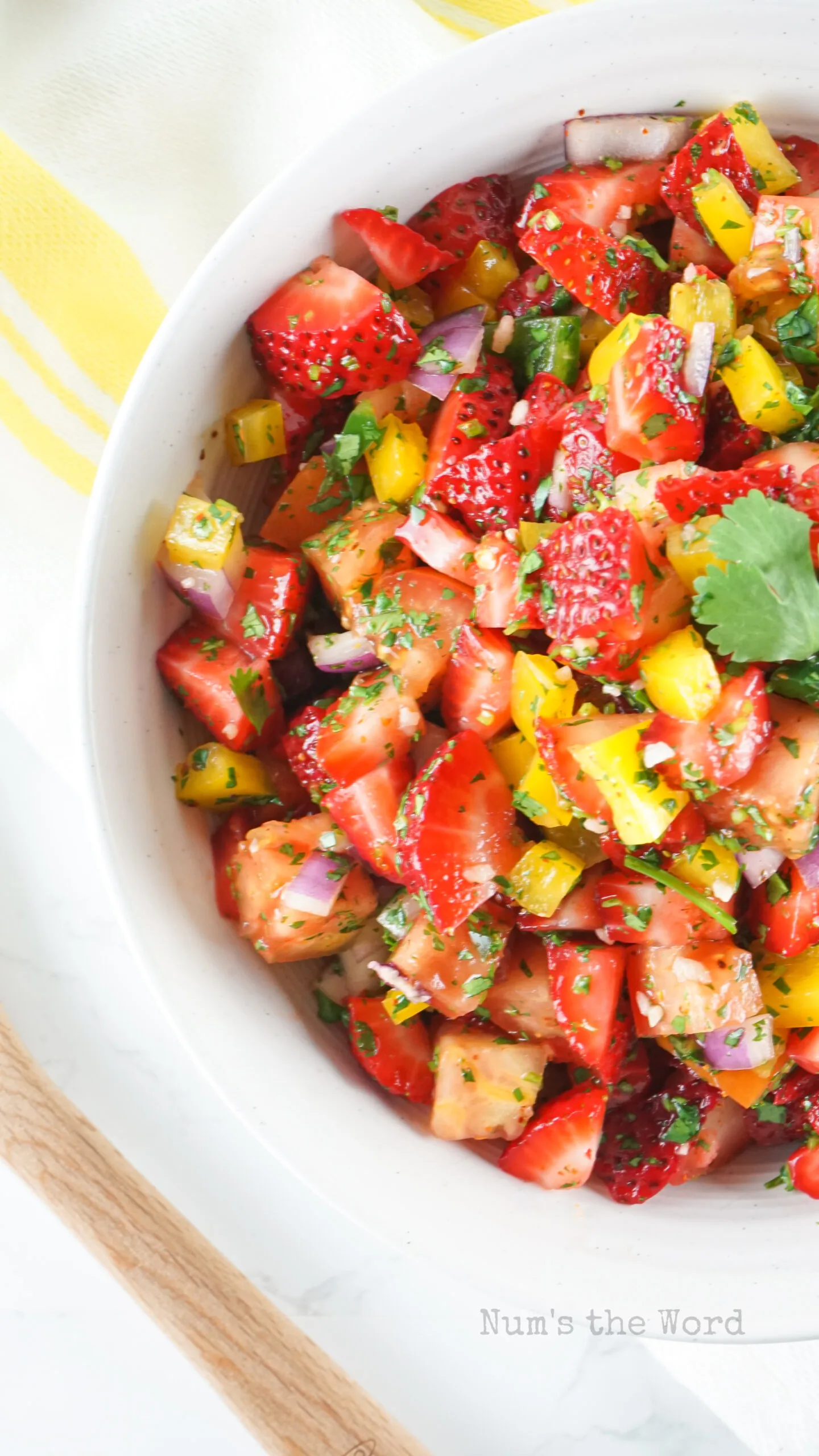 zoomed in image of strawberry salsa in bowl, top view looking down