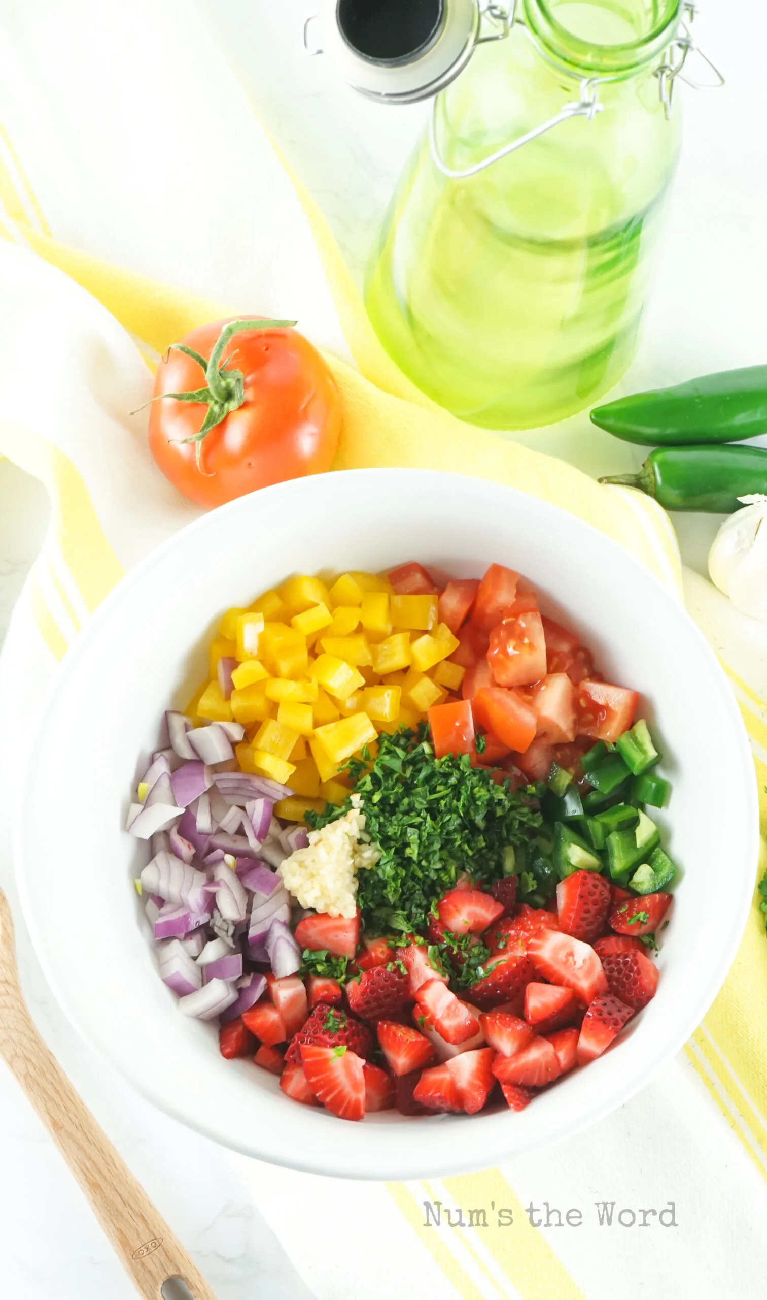 all ingredients for strawberry salsa in a bowl, unmixed