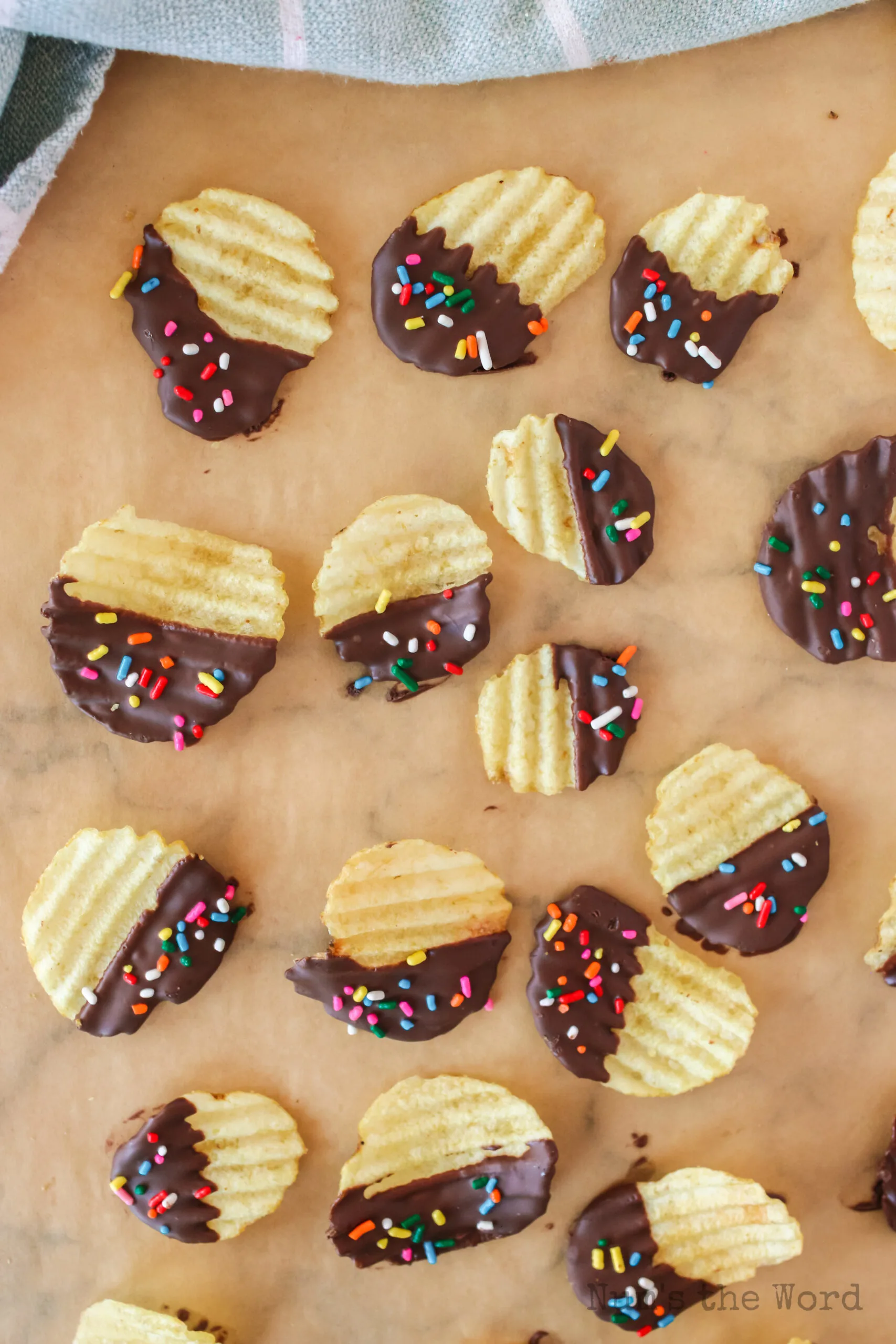 colored sprinkles on chips drying on parchment paper