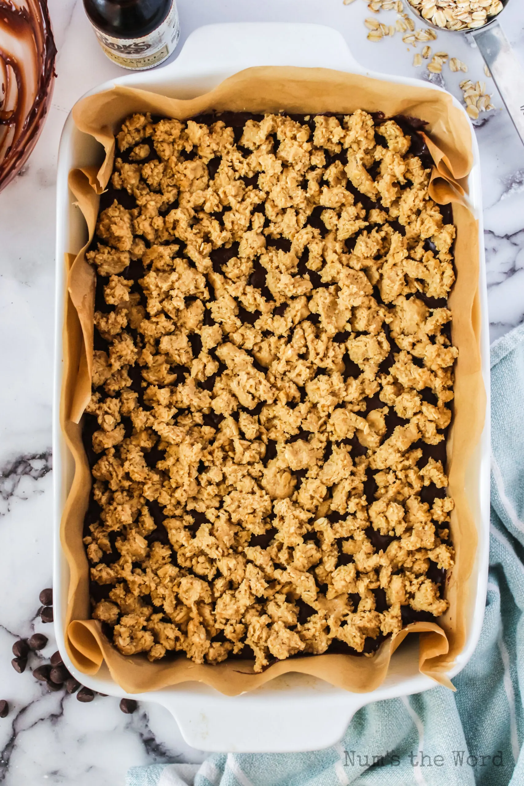 More oatmeal cookie dough placed on top of fudge layer