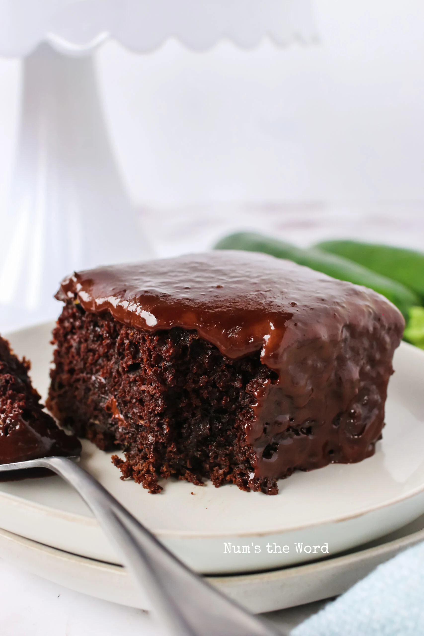 single slice of zucchini cake on a plate with a piece removed