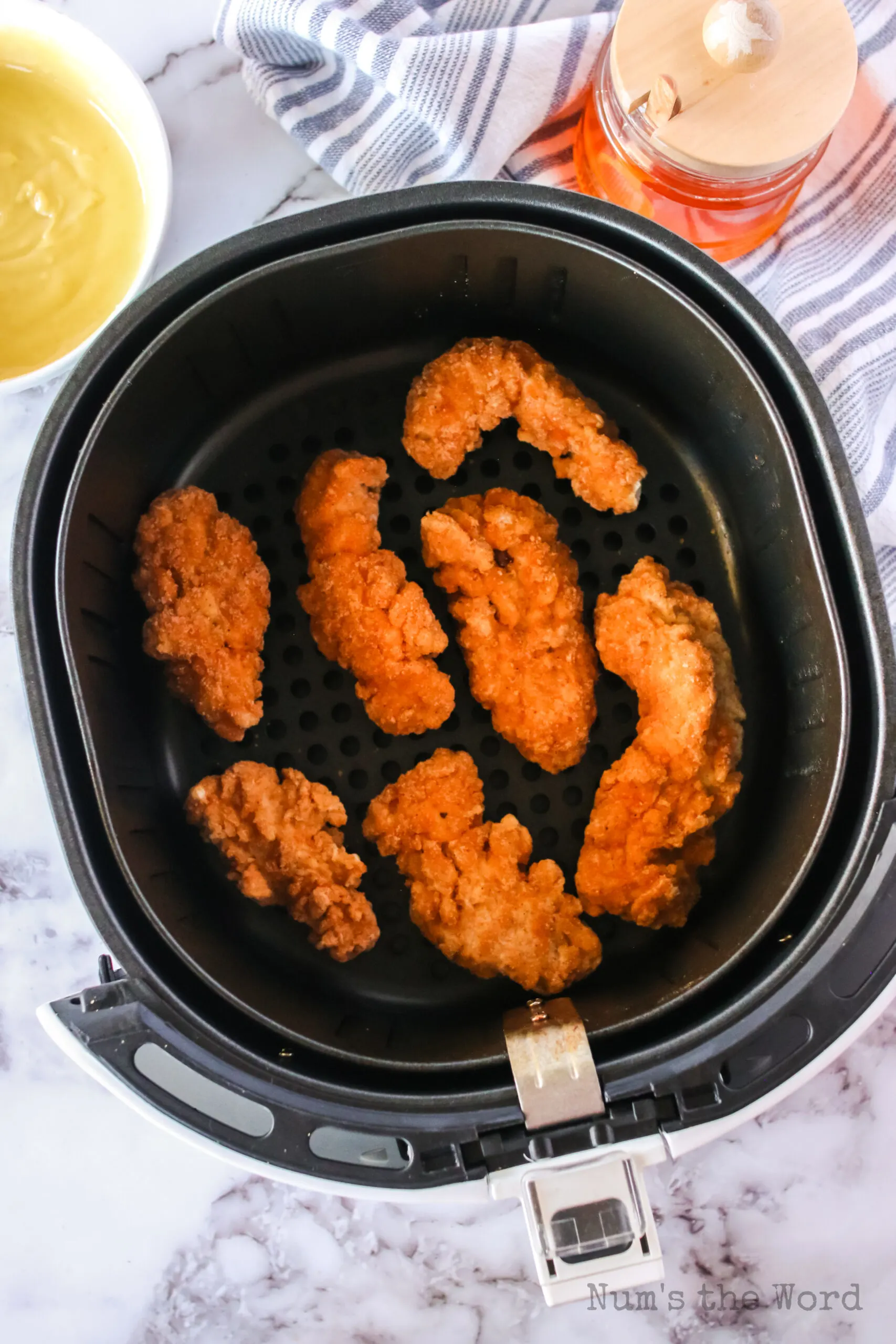 zoomed out image of strips in air fryer