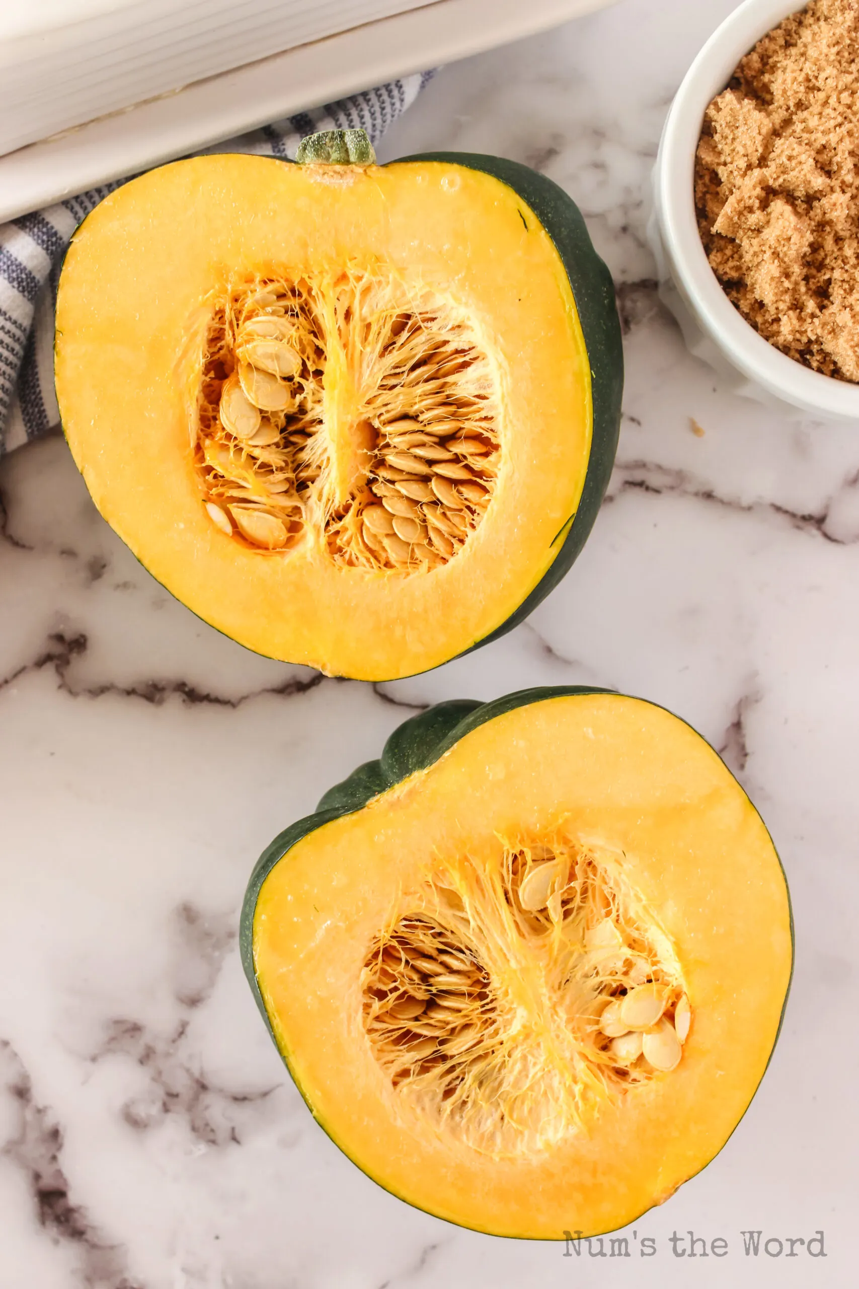 acorn squash cut in half with seeds still in the squash