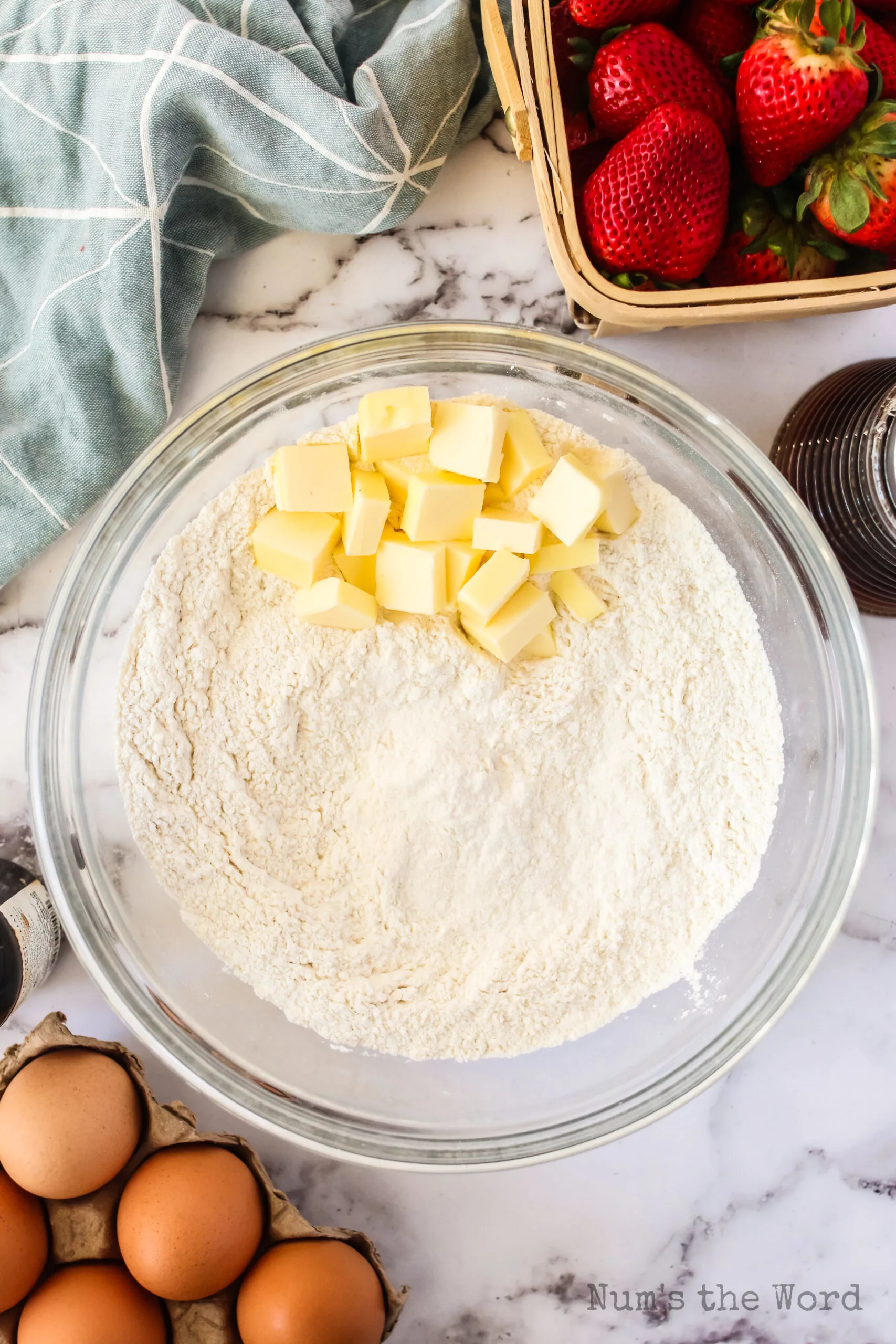 flour, salt, sugar and baking powder mixed together with cold butter cubes added to mixture