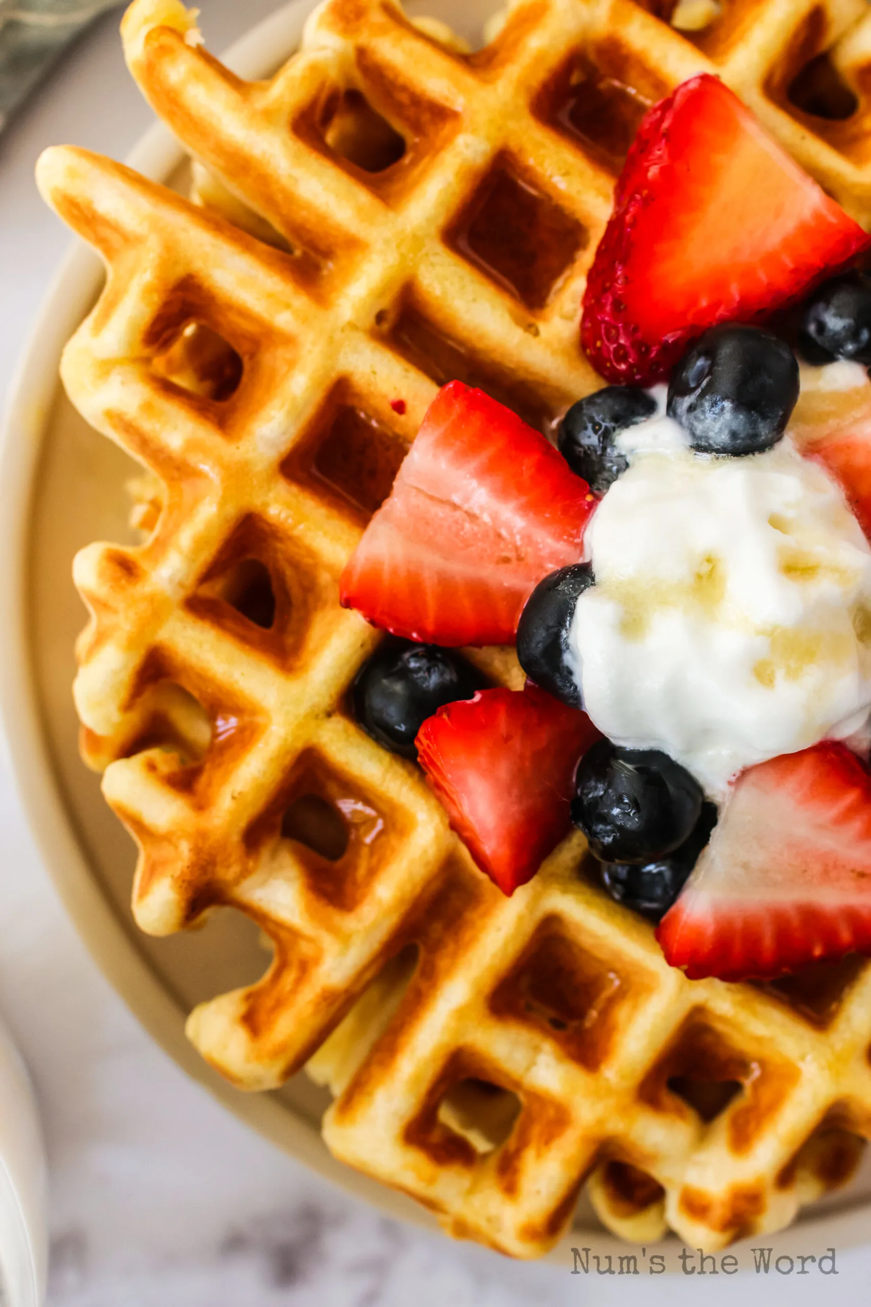 fresh fruit and butter on top of waffles