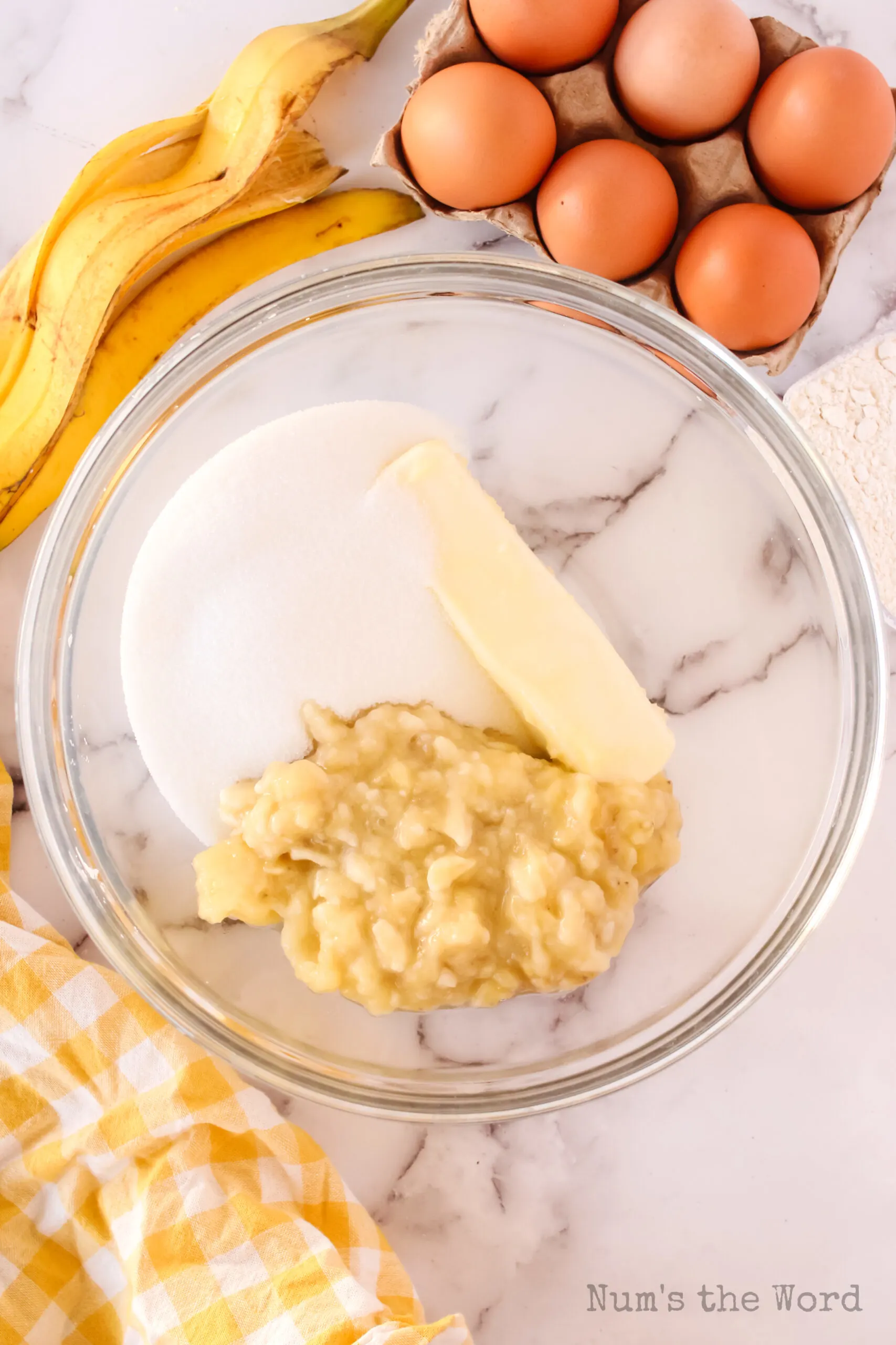 butter, sugar and mashed bananas in a bowl