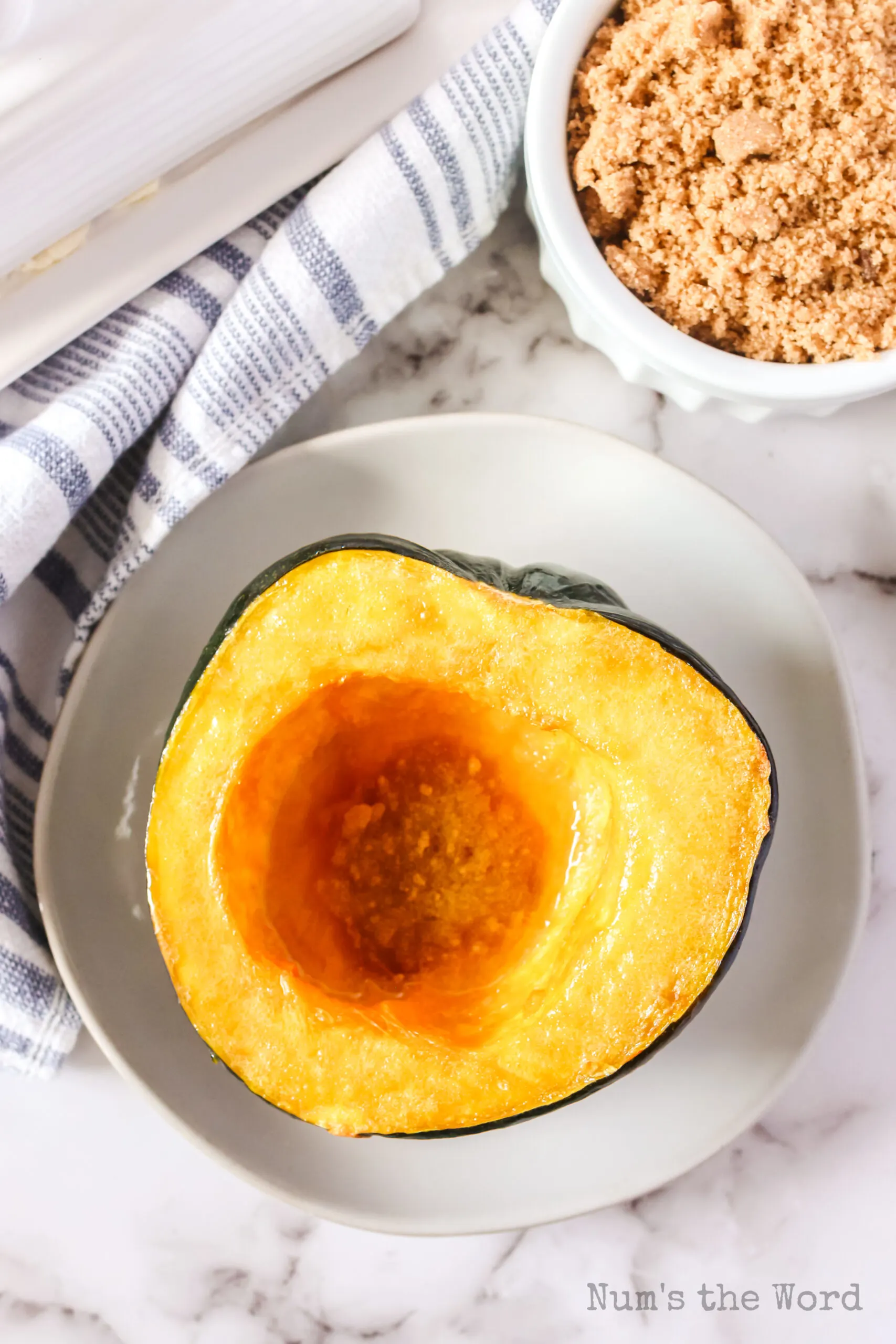 zoomed out image of single squash half on plate ready to devour