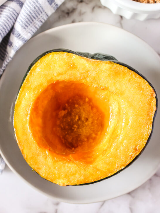 zoomed in image of squash half on plate with butter brown sugar mixture in the center well.