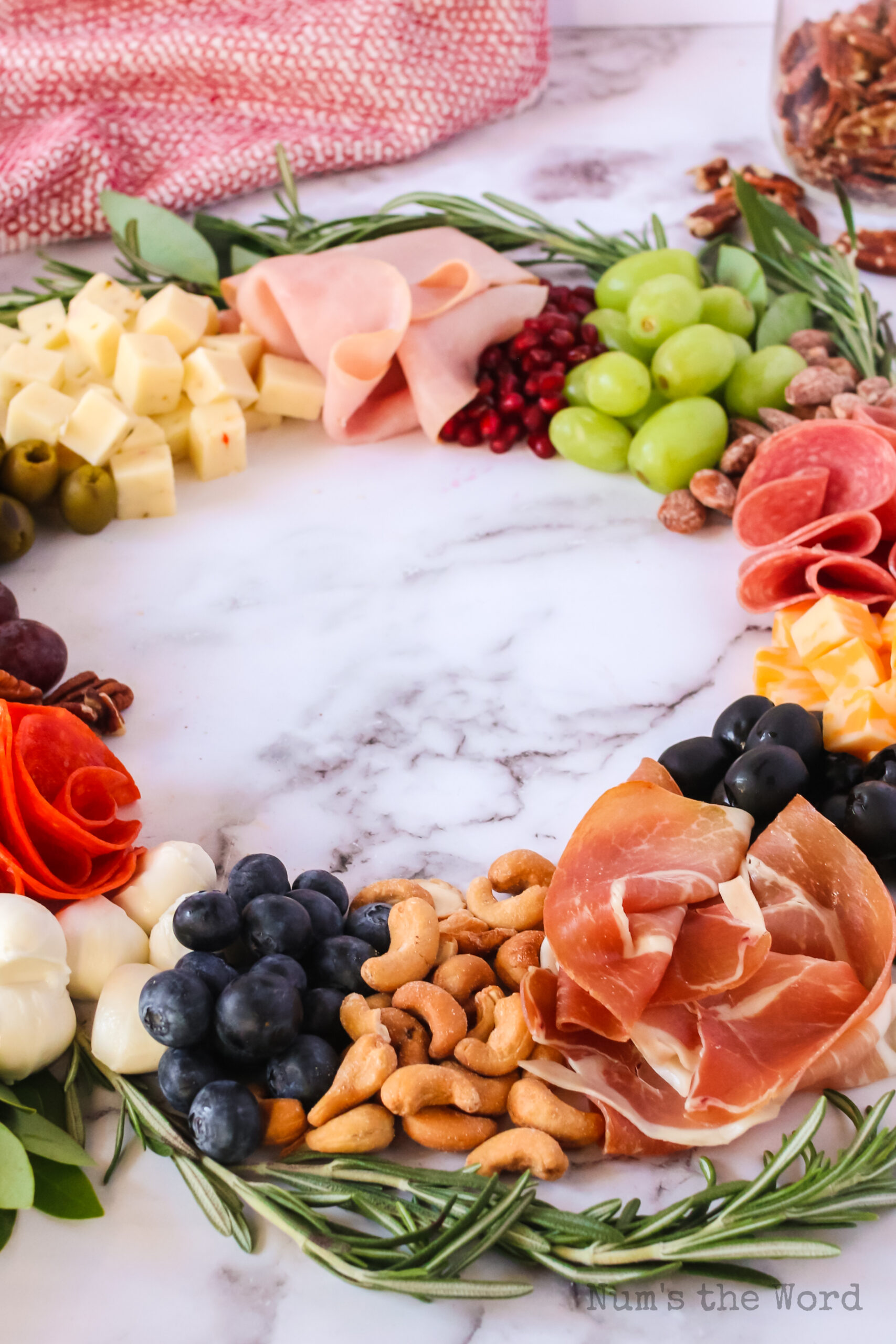 zoomed out image of charcuterie board on a table, side view