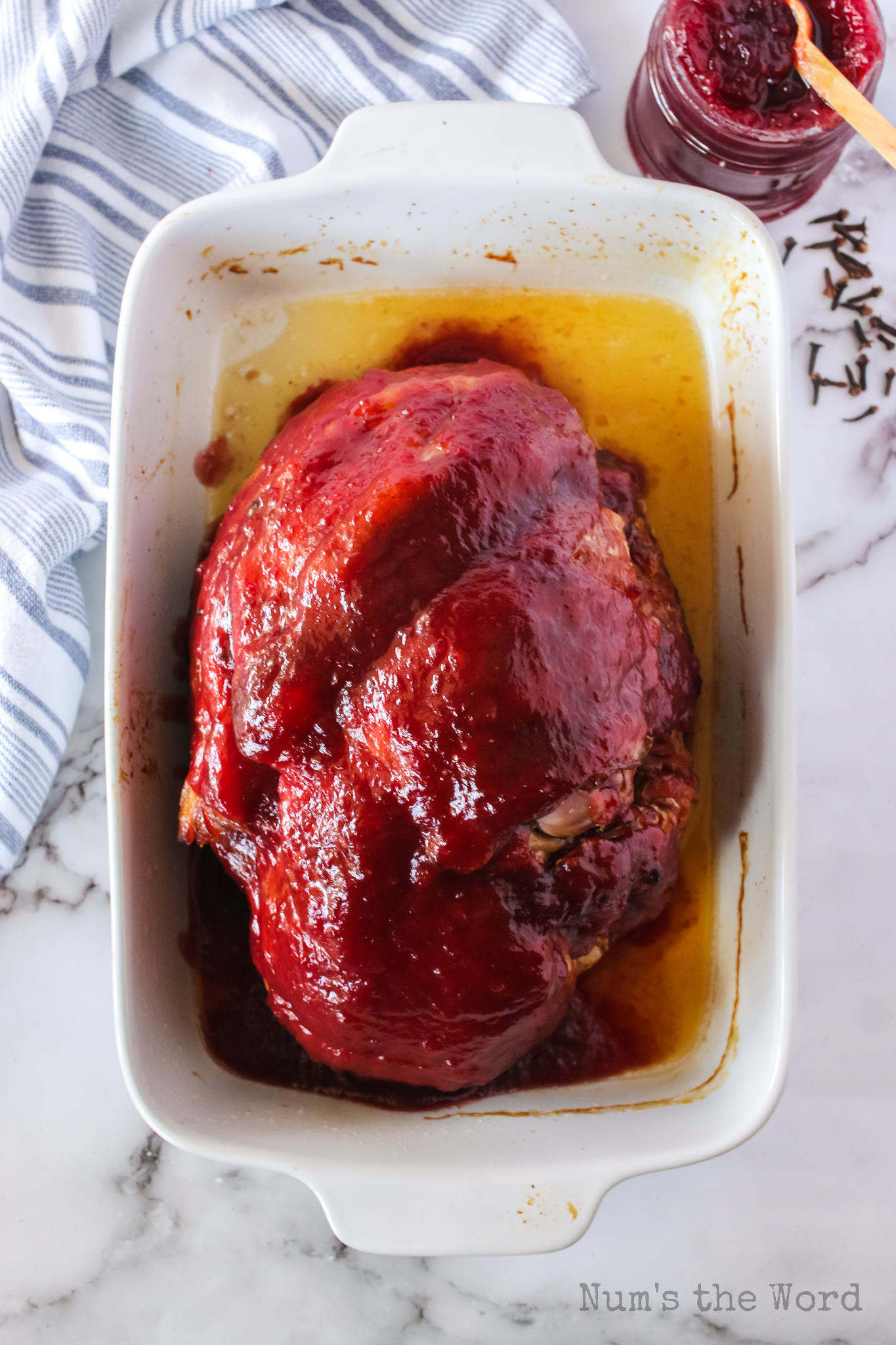 cranberry glaze spread over ham