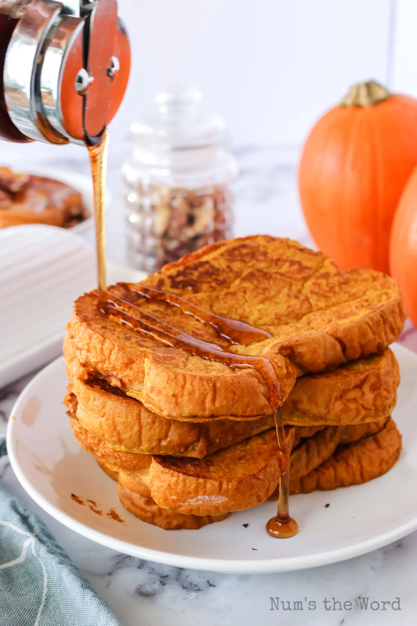 maple syrup being drizzled over 4 pieces of french toast