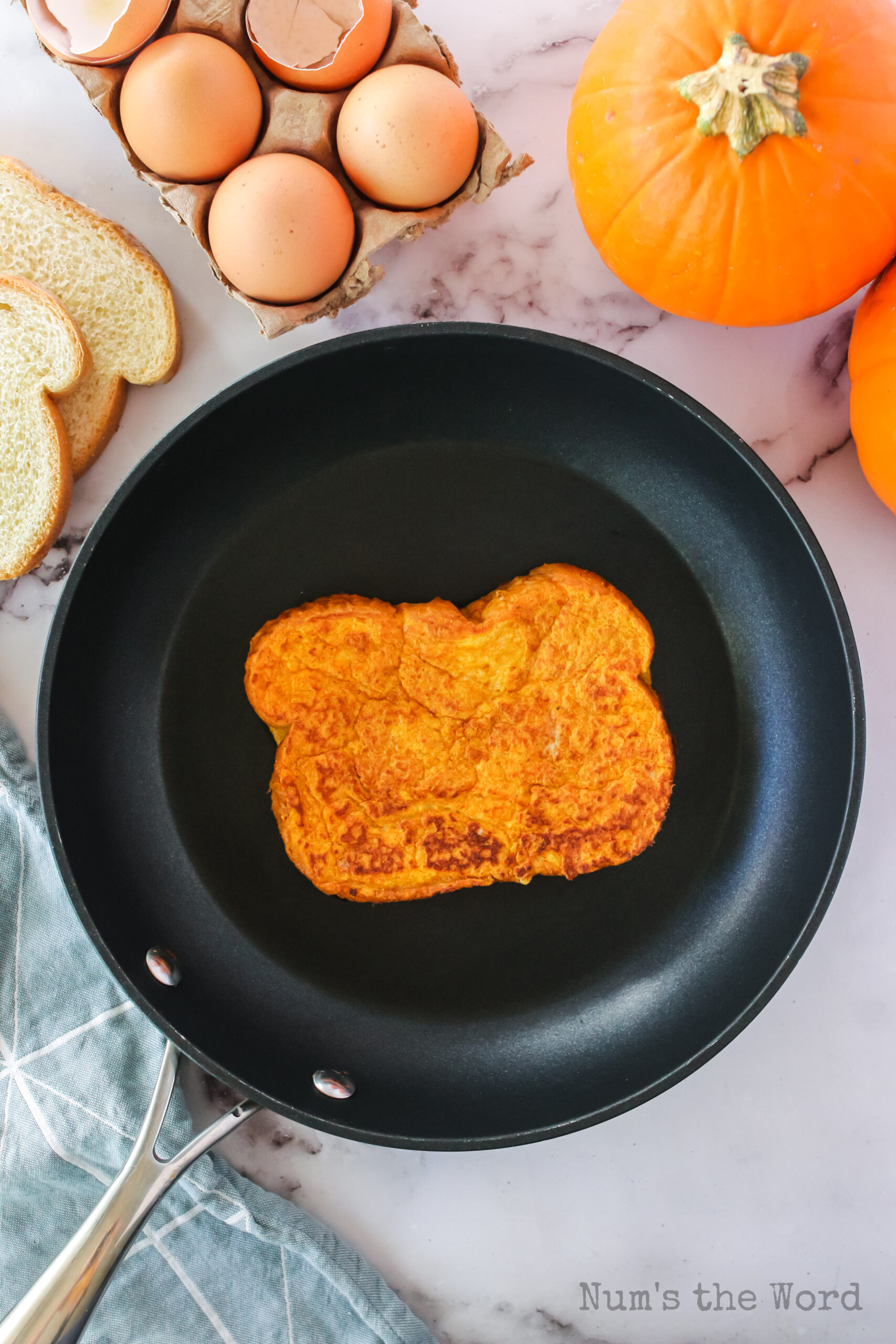 pumpkin french toast being cooked in a skillet