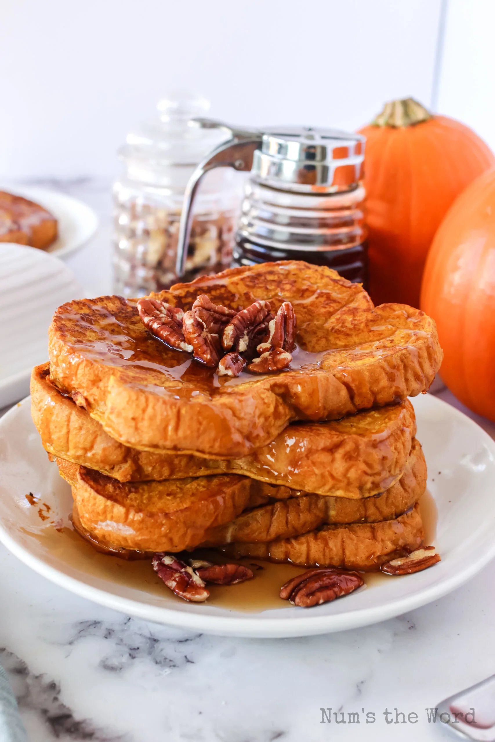 zoomed out image of french toast with maple syrup