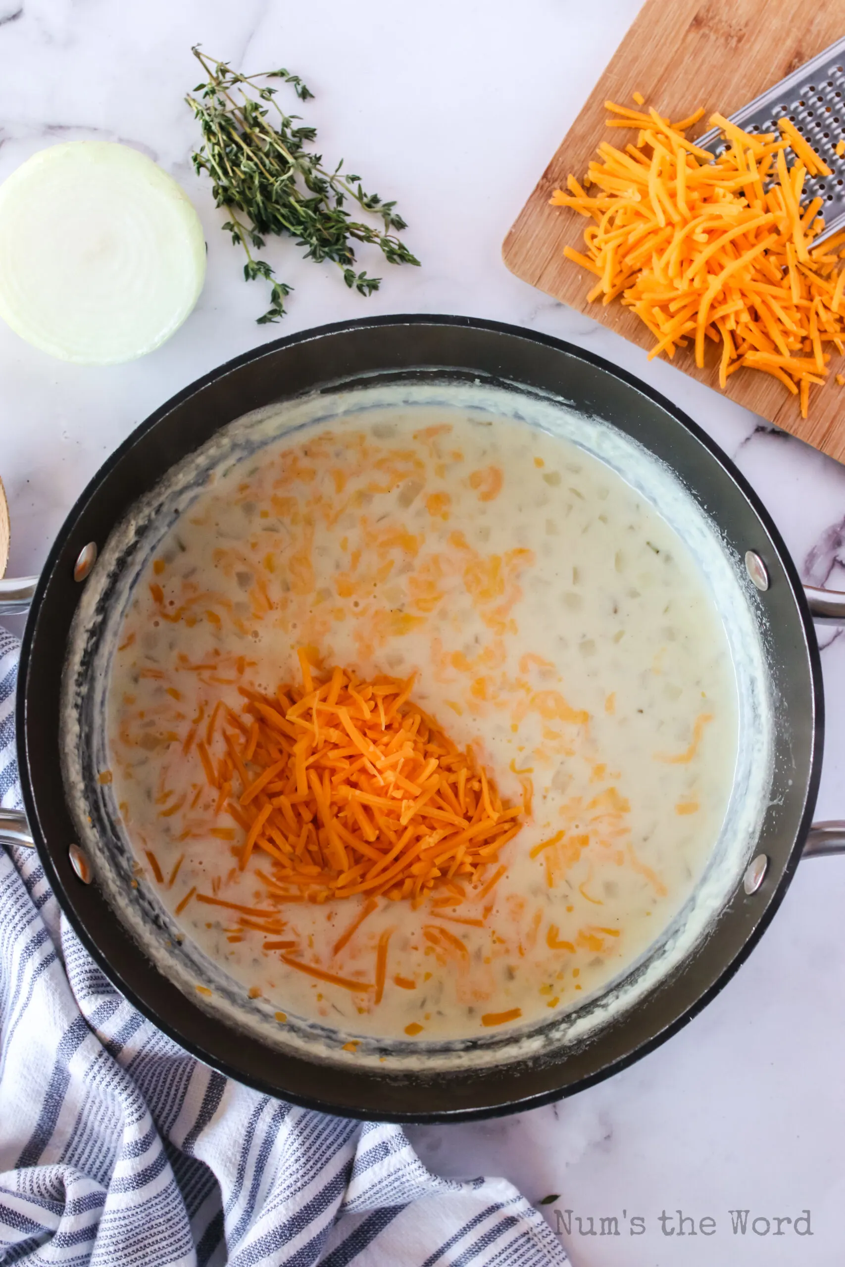 cheese, mustard, salt, thyme, black pepper chicken broth and cheese added to onion mixture.