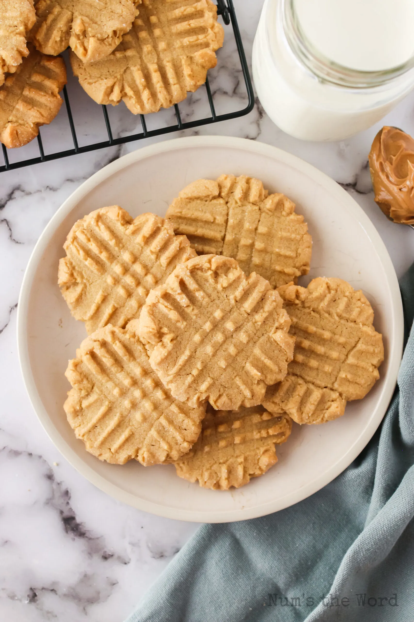 cookies on a plate with a glass of milk