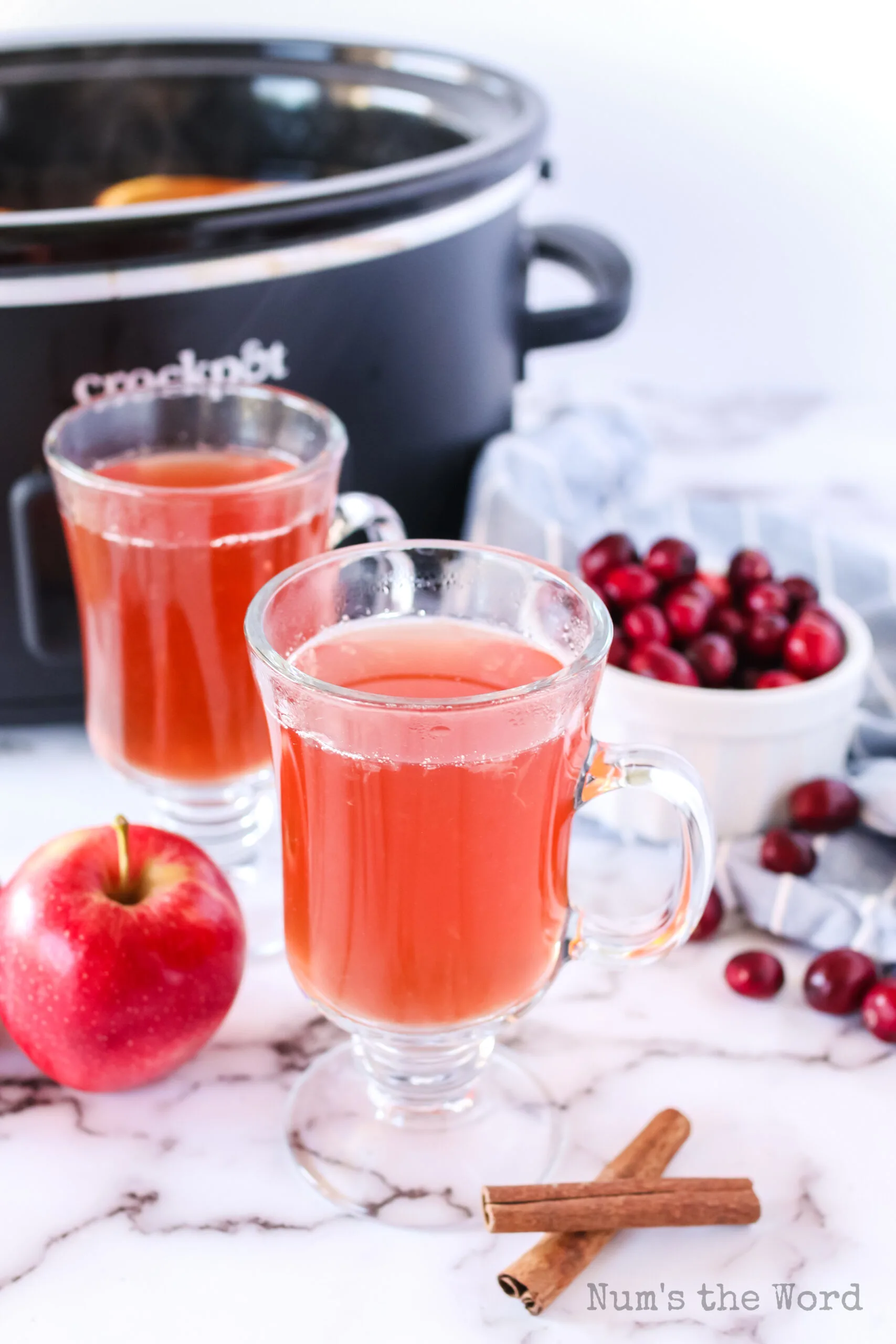 zoomed out image of 2 cups of cider