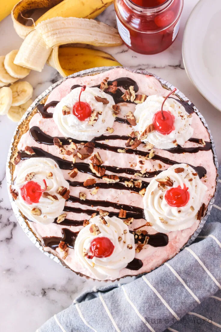 zoomed out image of entire pie with dollops of whipped cream