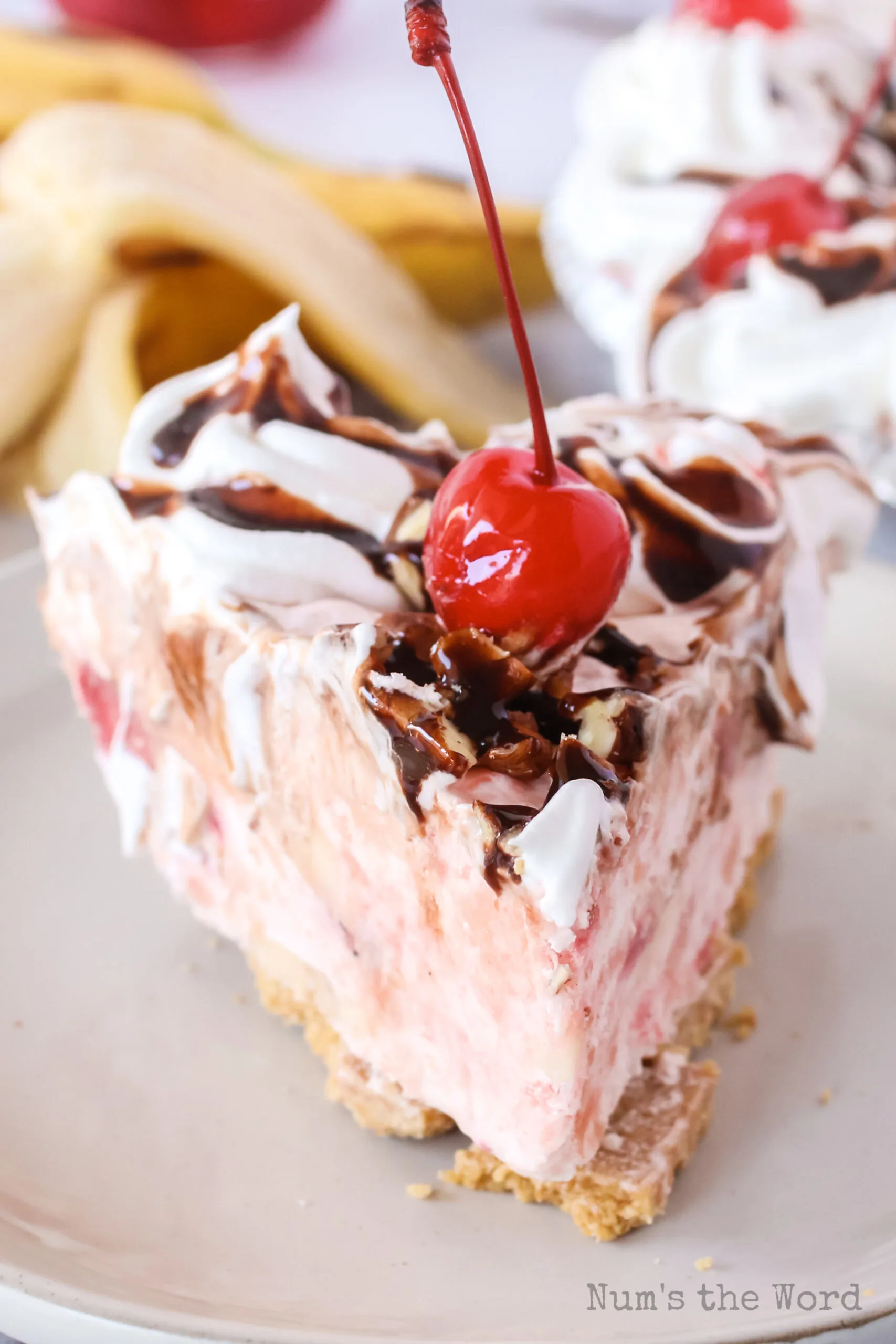 slice of pie on a plate with a cherry