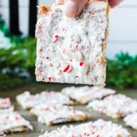 hand holding up a square of peppermint christmas crack