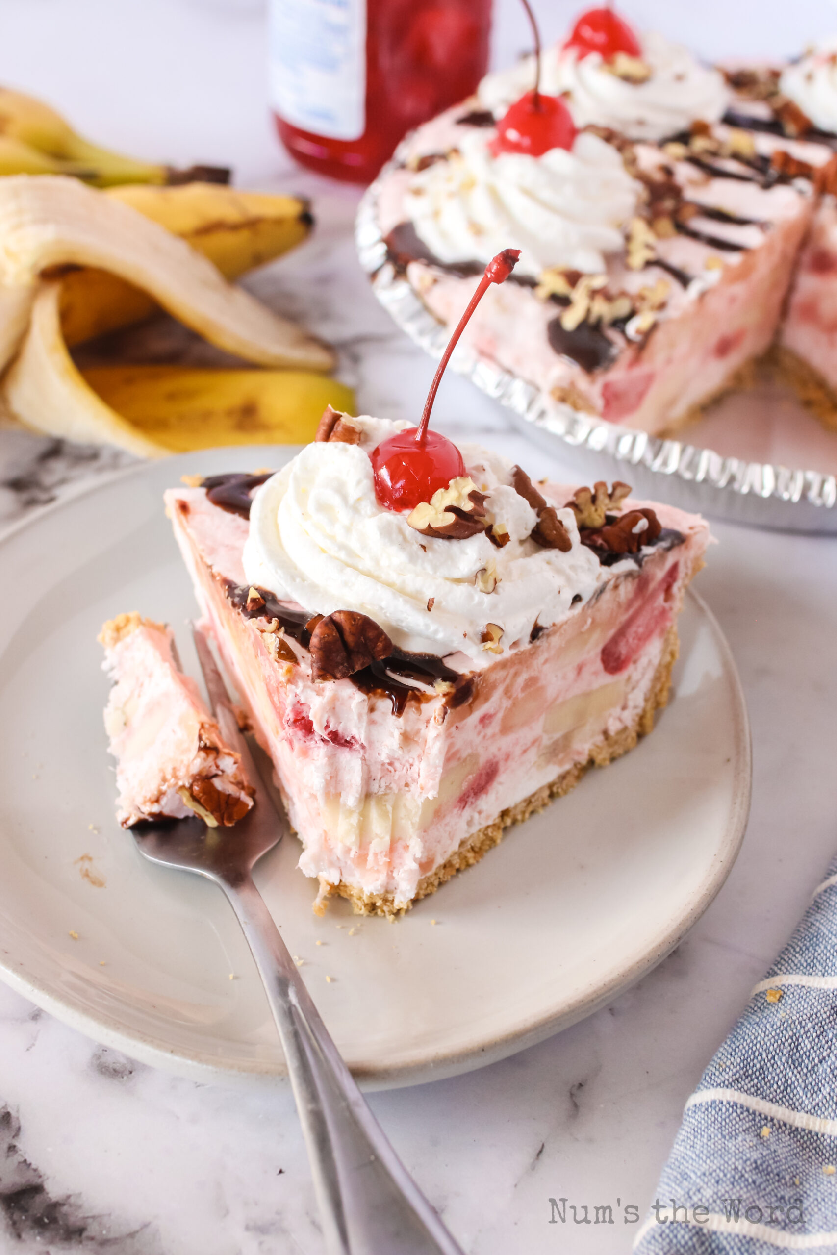 slice of banana split pie on a plate with a forkfull