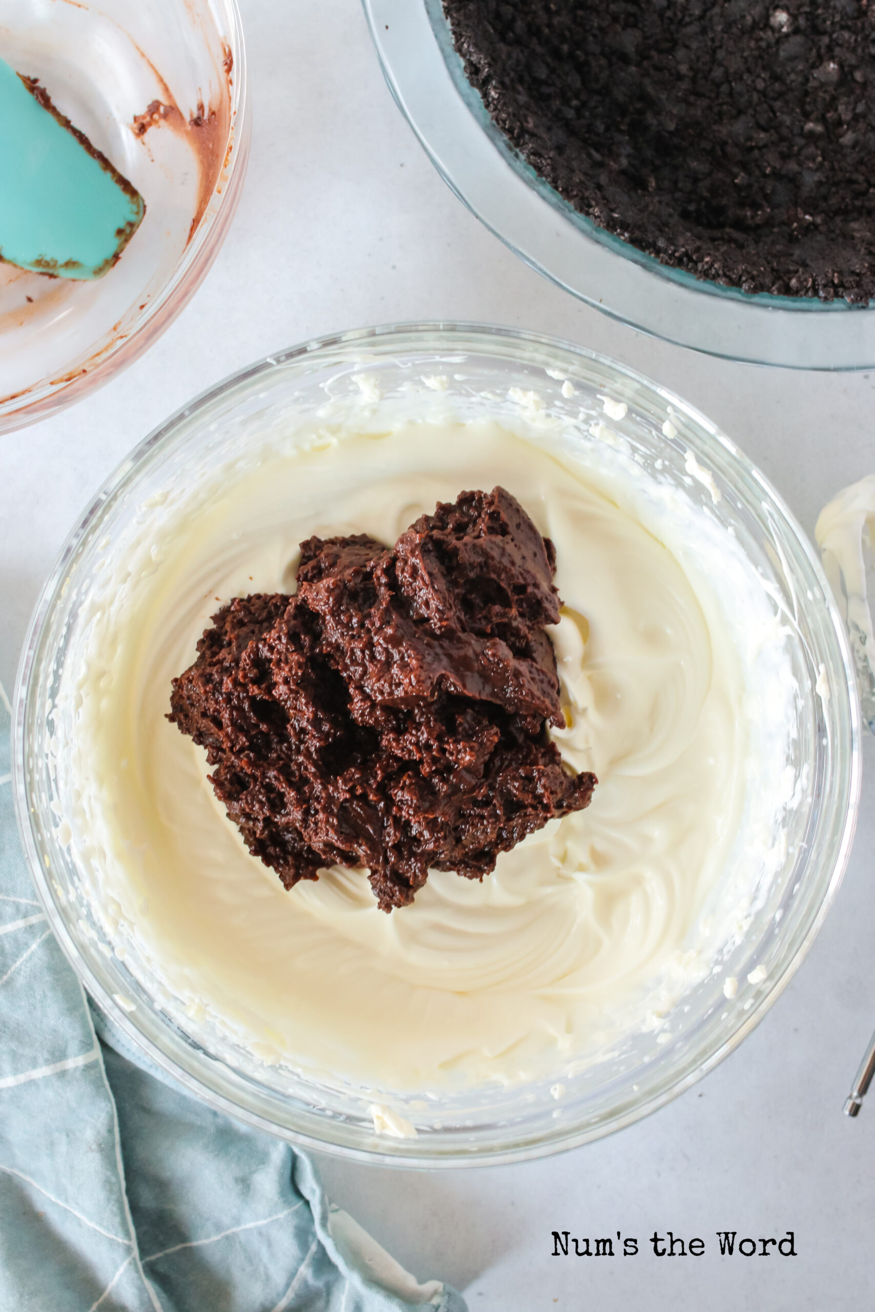 Cream cheese, sugar and heavy whipping cream mixed together in a bowl. Chocolate pudding mixture added to cream cheese mixture but unmixed