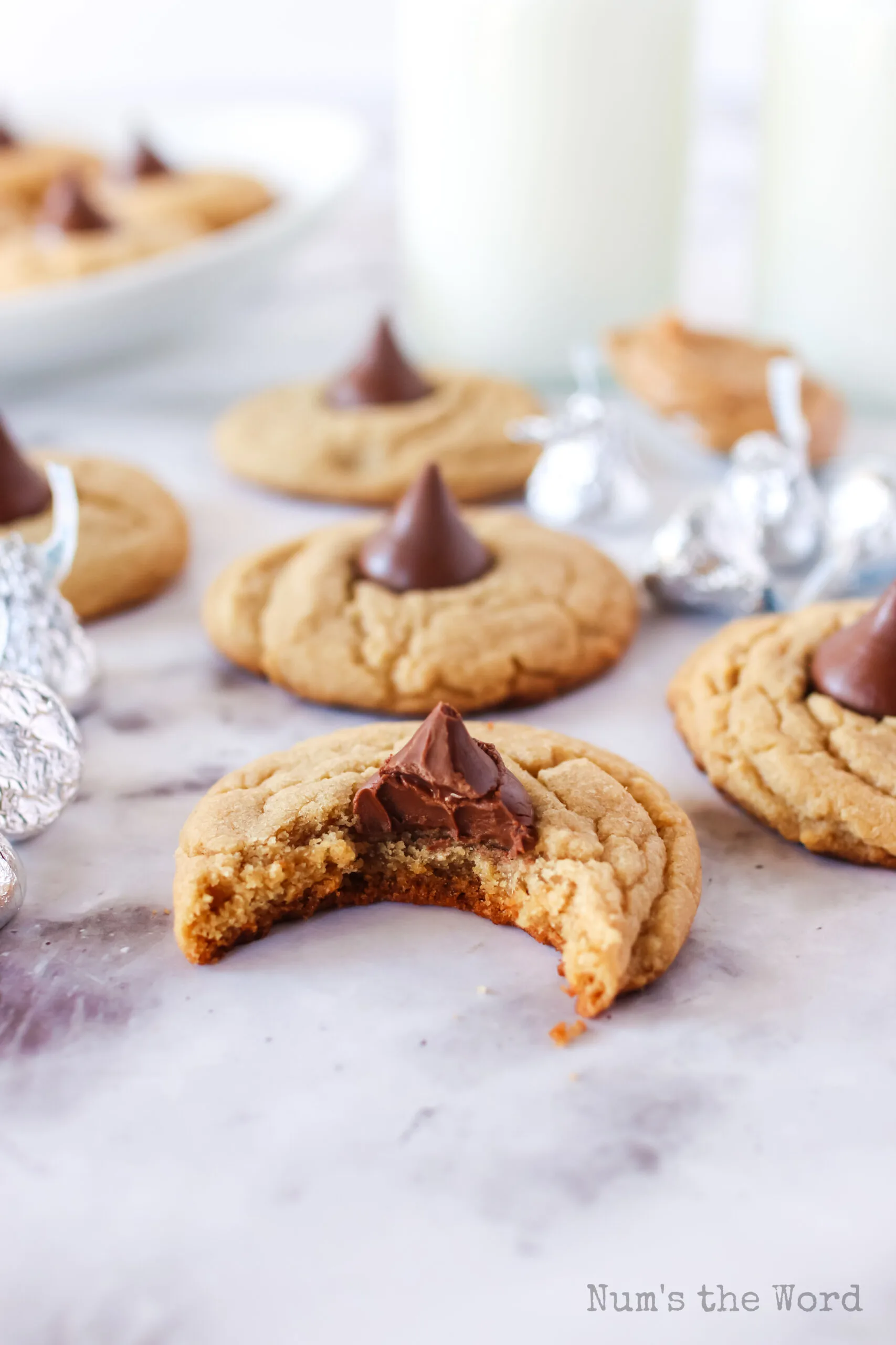 a bite removed from a cookie with others laid out on counter