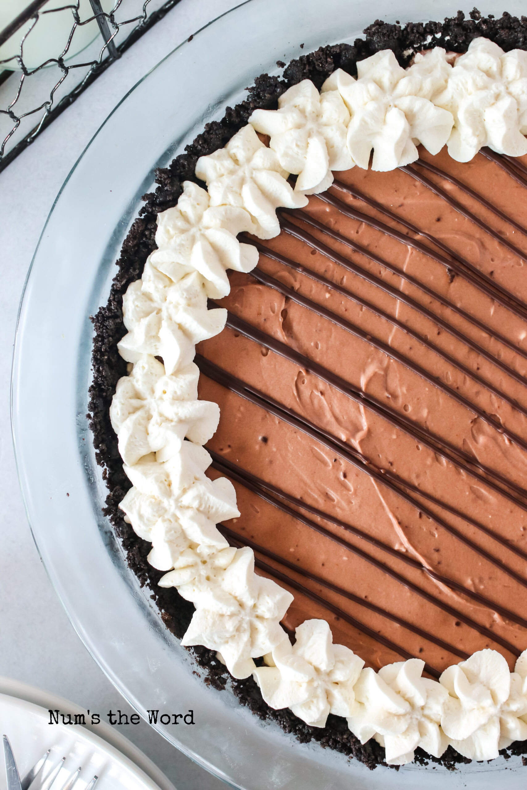 zoomed in image of cheesecake with chocolate and whipped cream