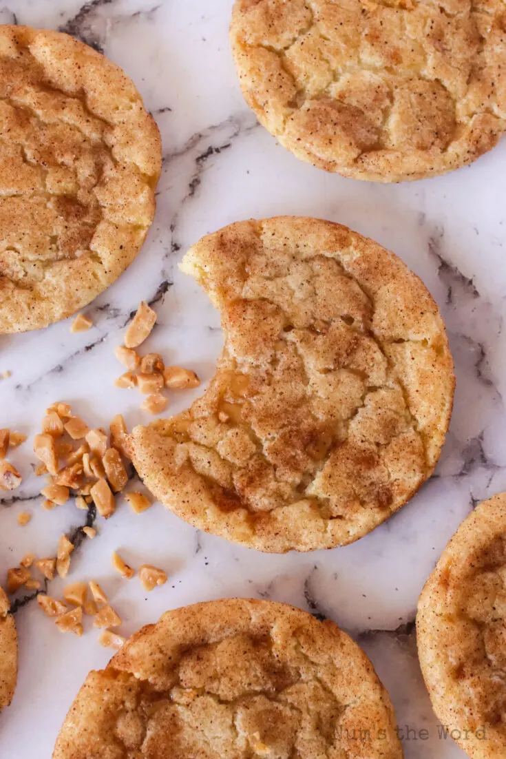 cookies laid out on counter with a bite removed from one cookie