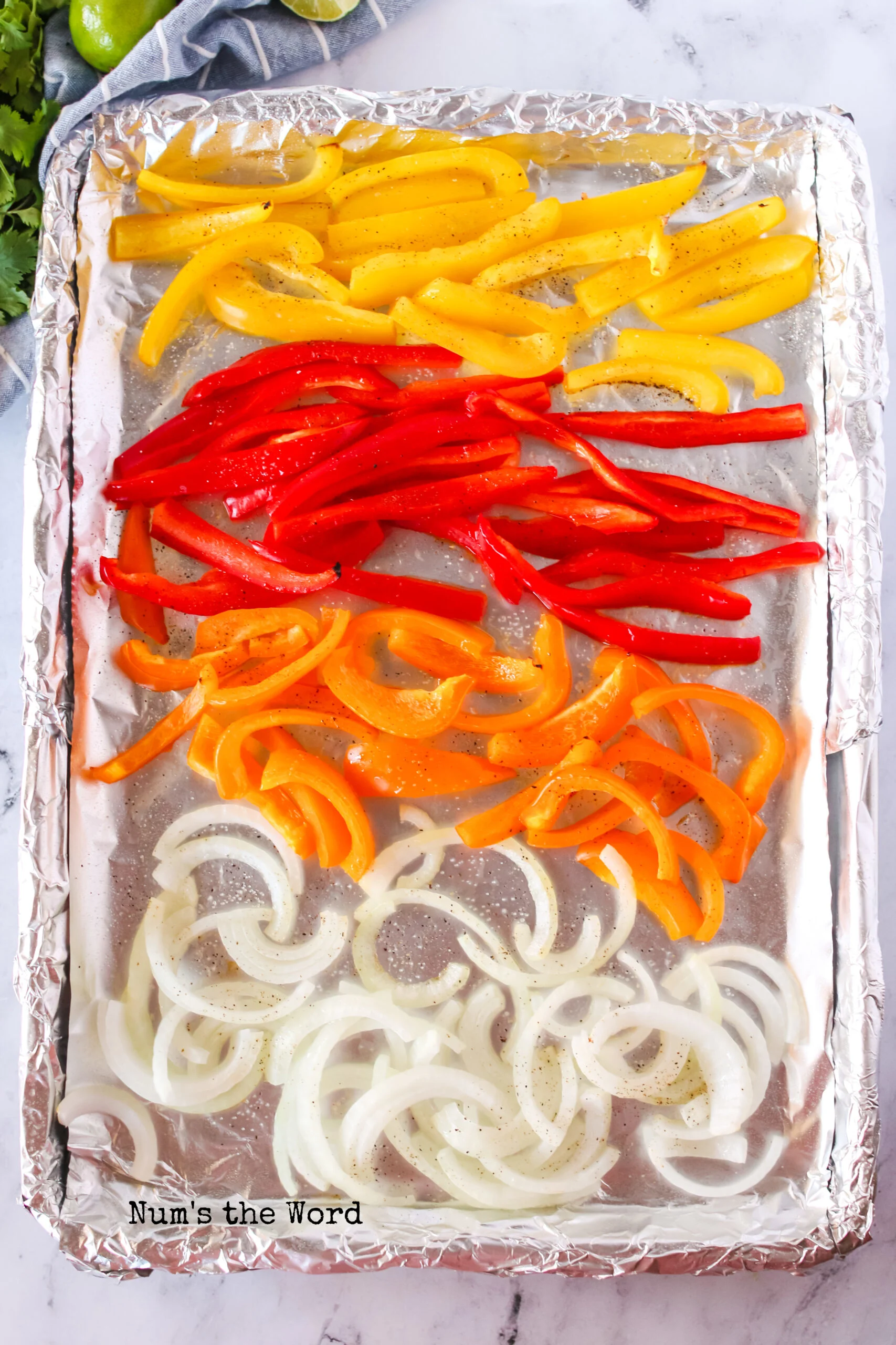 onions and peppers on a sheet pan, spread out.