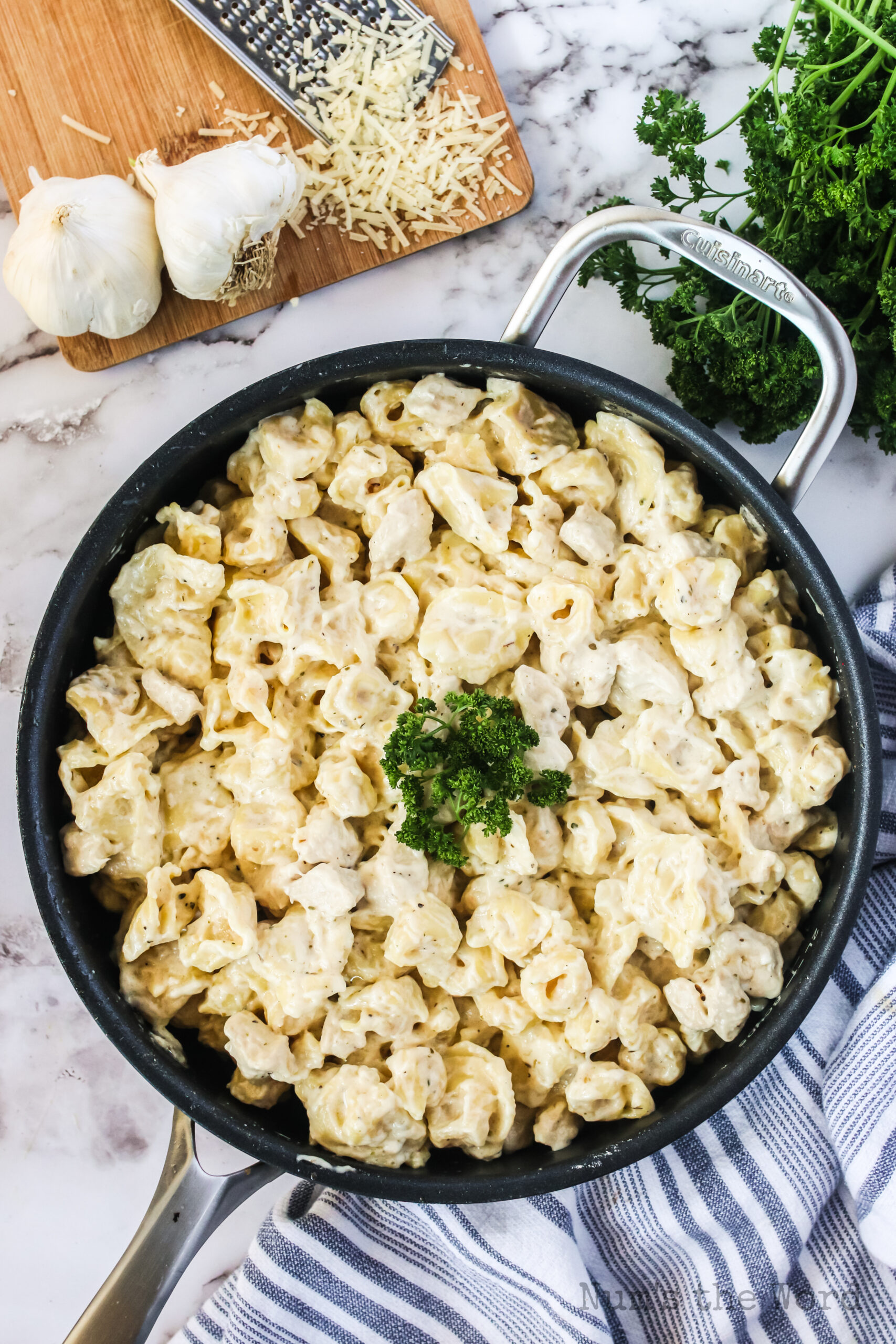 zoomed out image of garlic tortellini alfredo in pan