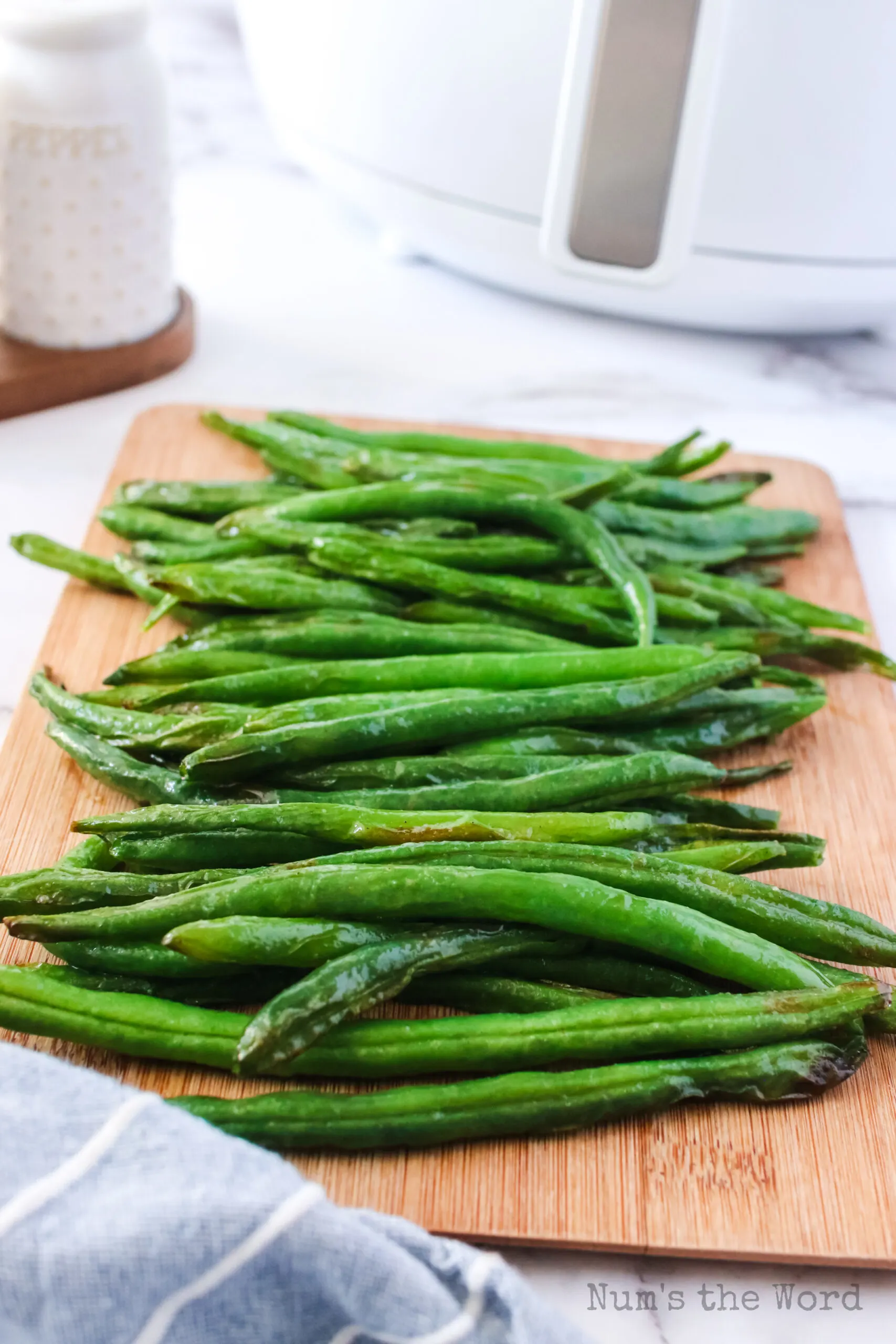side view of green beans on serving board