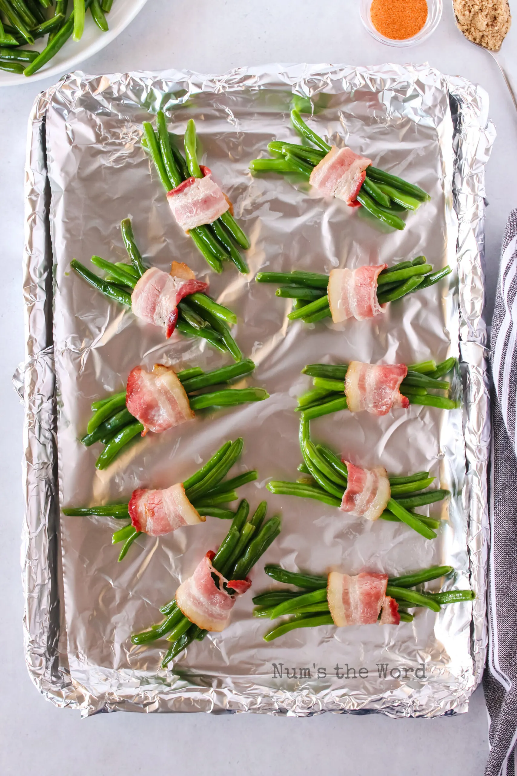 several green beans wrapped in bacon