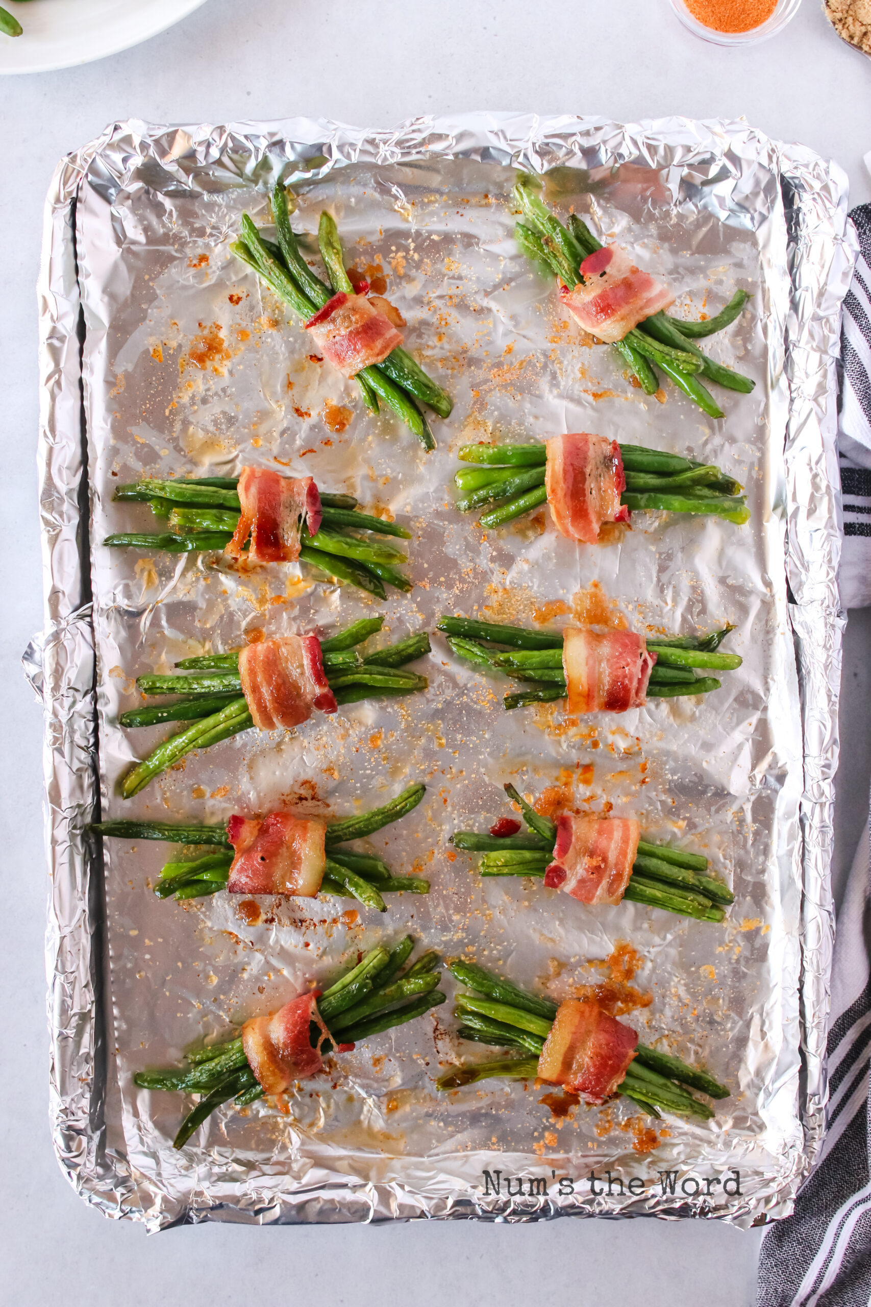 cooked green bean bundles on a cookie sheet