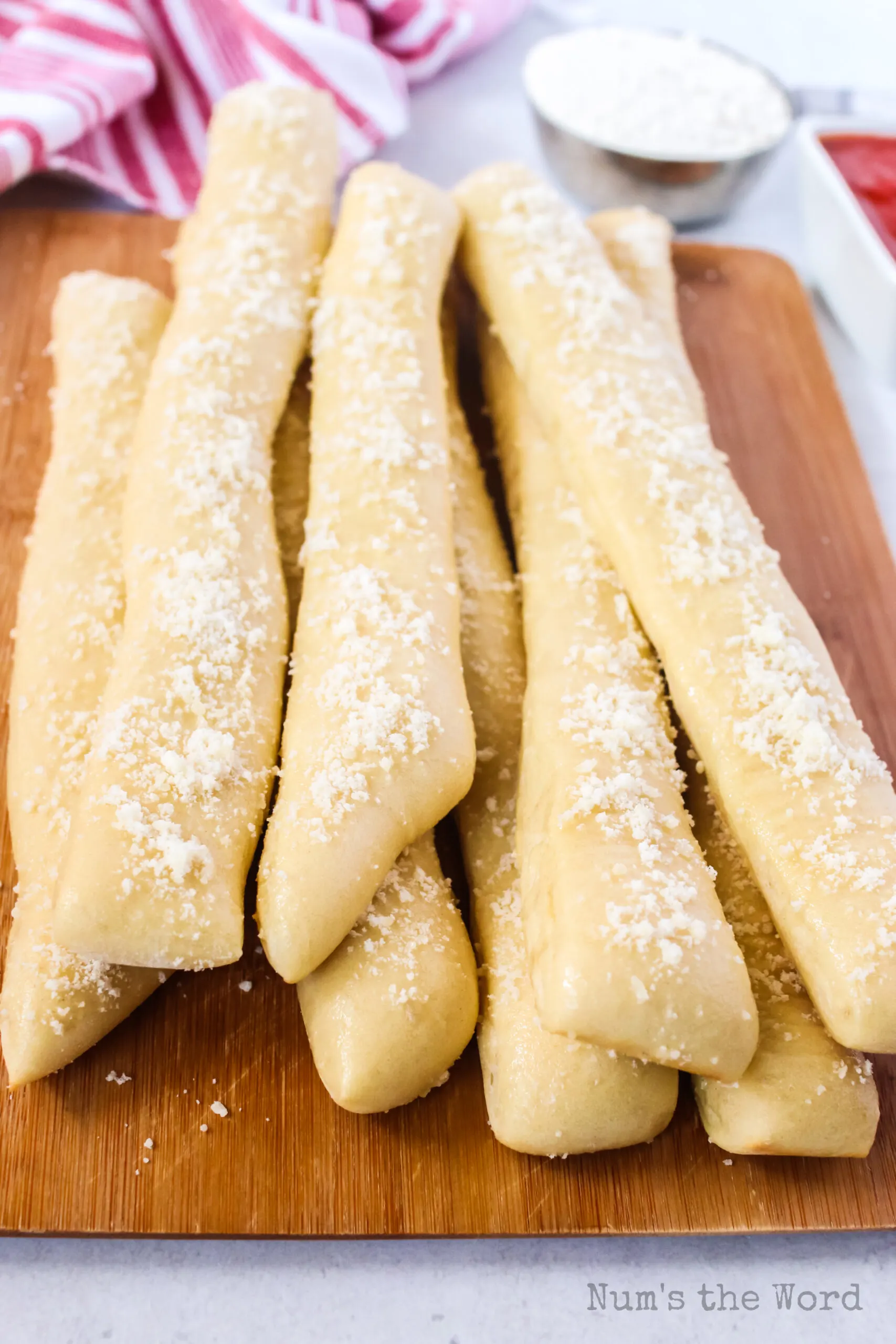 bread sticks baked and on wooden serving board