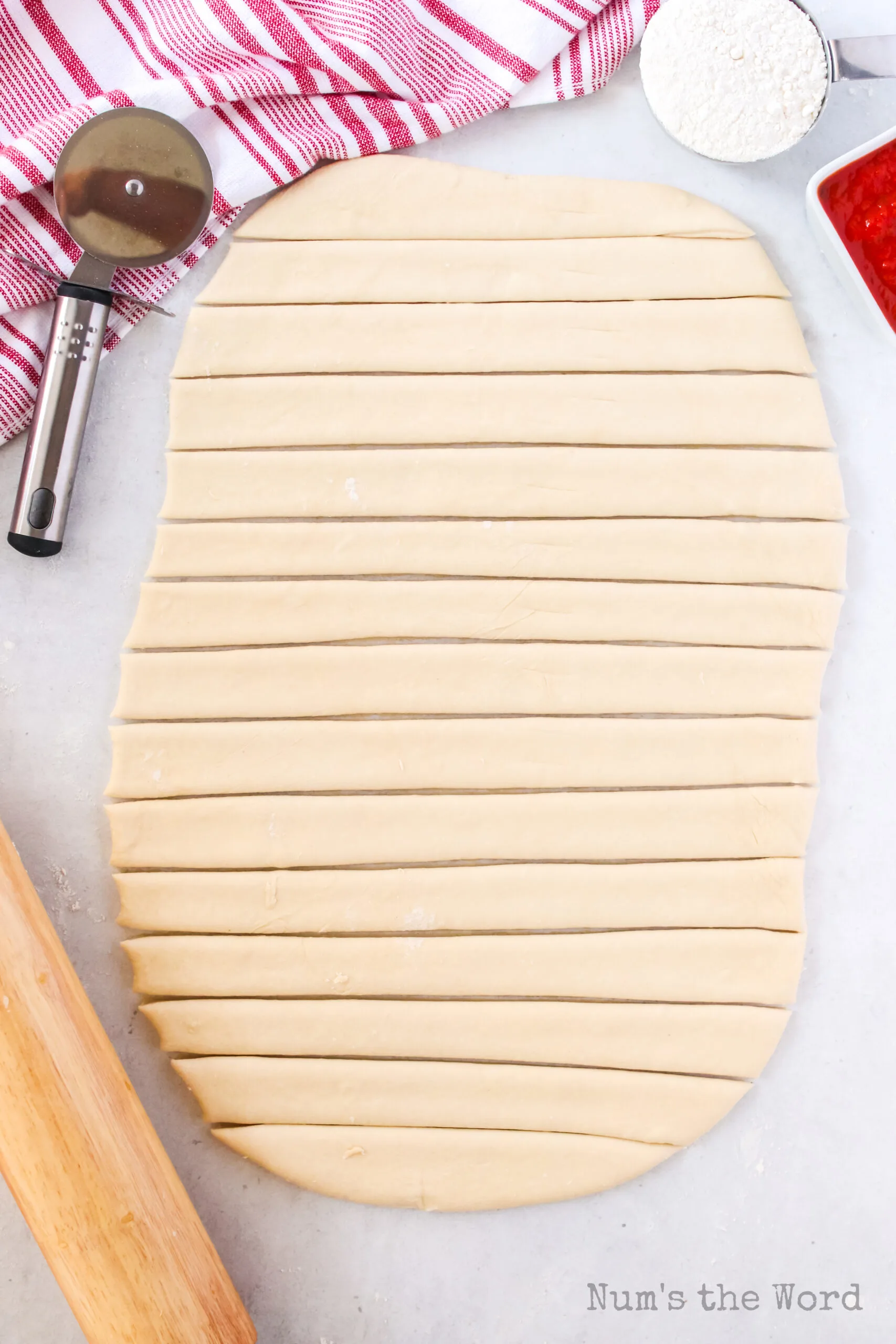 bread dough rolled out and cut into strips