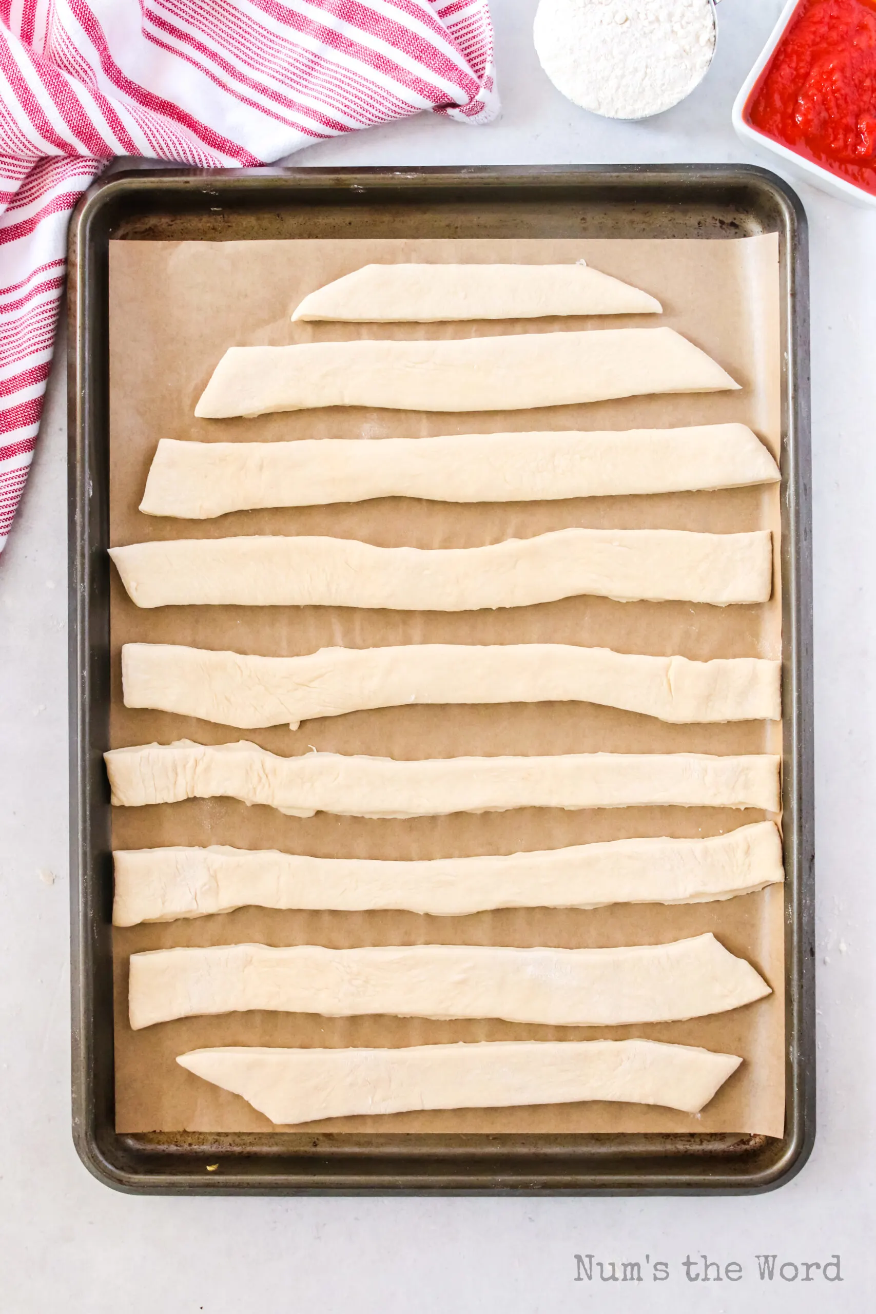 crazy bread dough strips on baking sheet