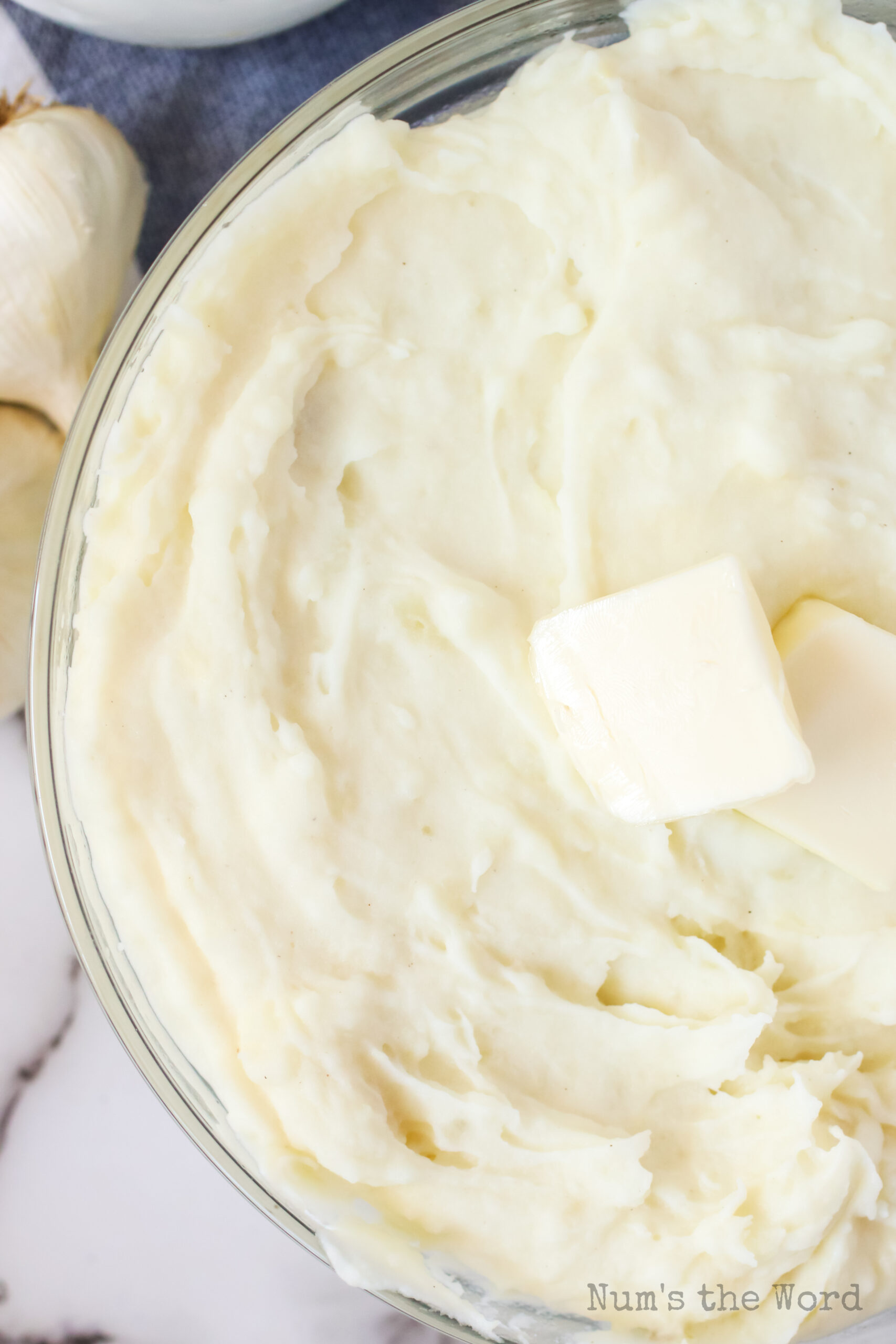zoomed in image of mashed potatoes with a pat of butter on top