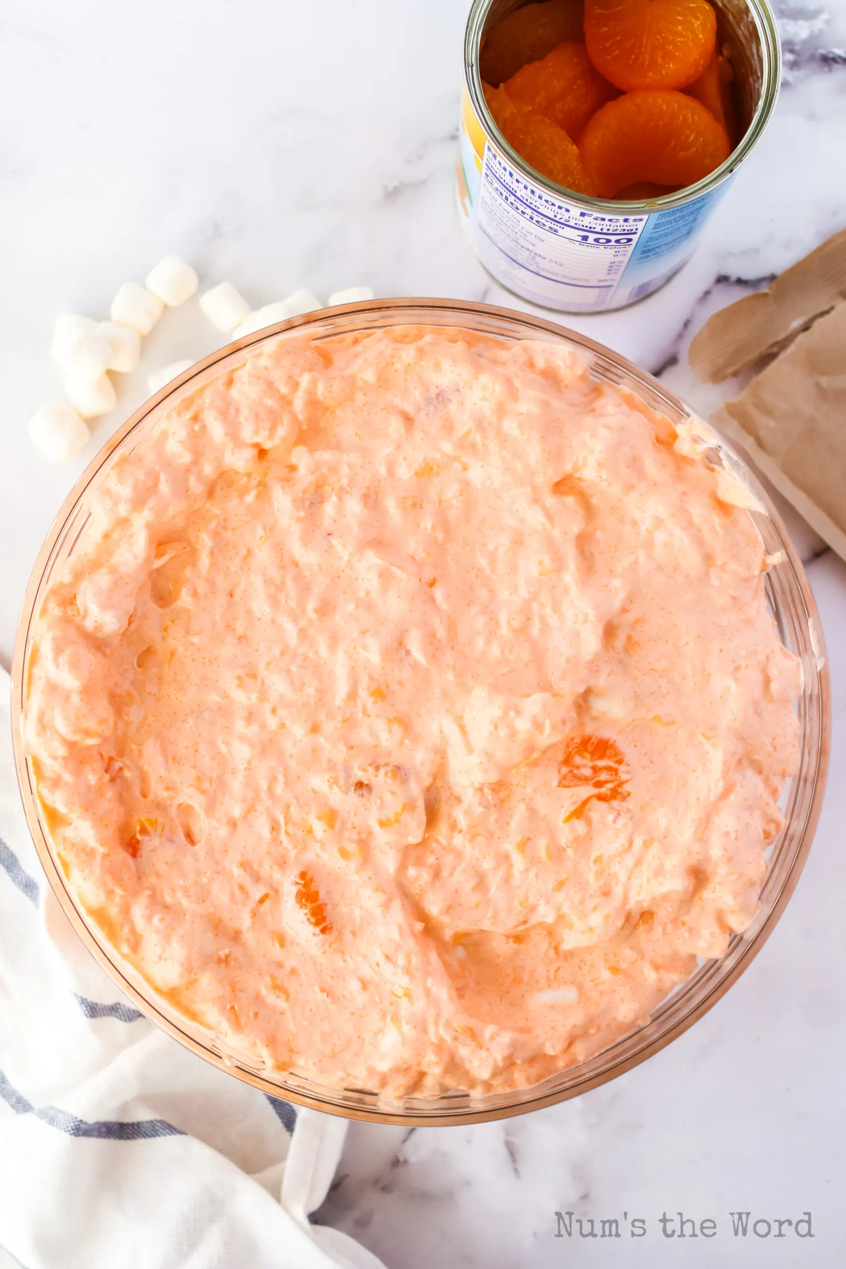 zoomed out image of orange jello in serving bowl, chilled