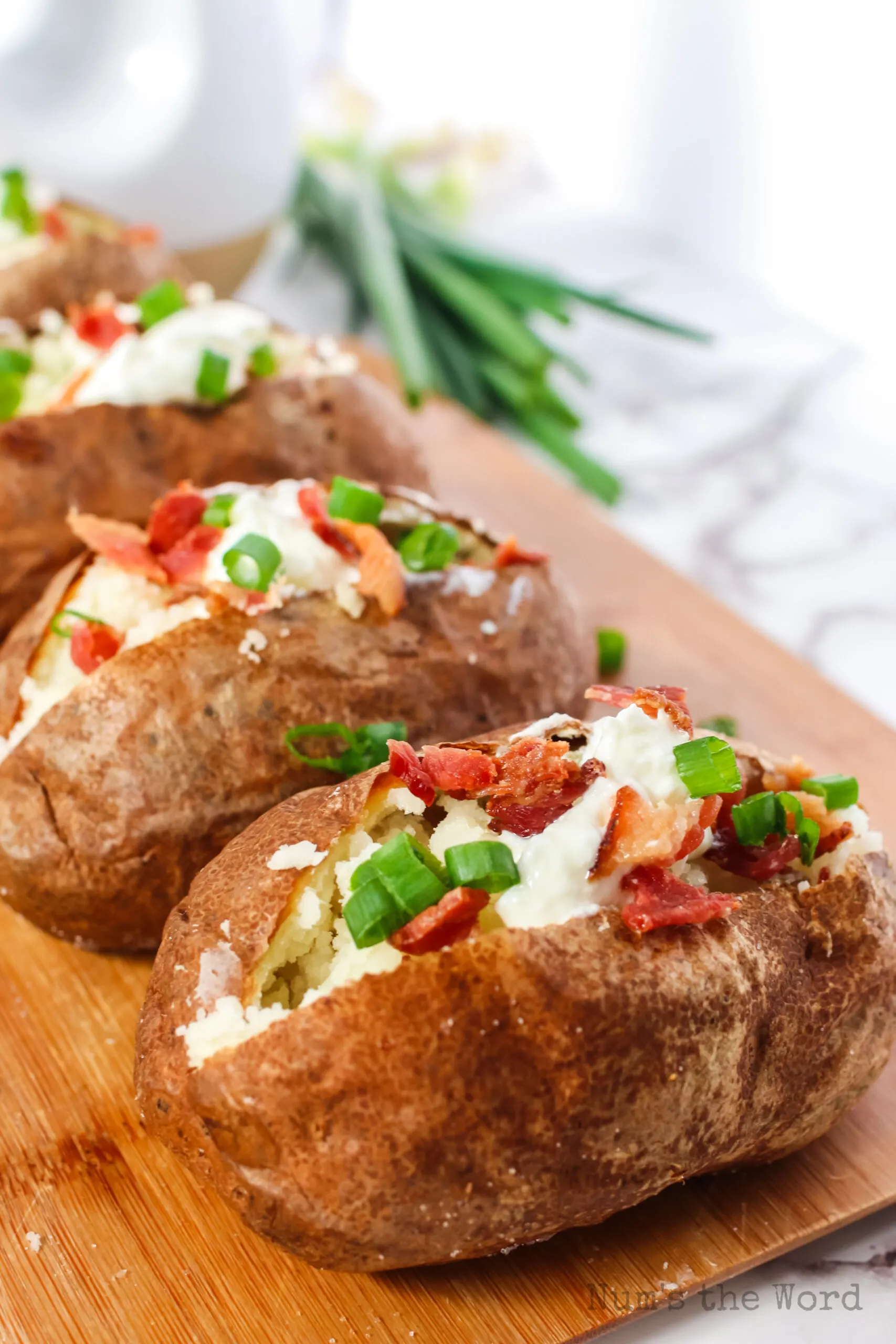 Side view of split potatoes on cutting board fully loaded