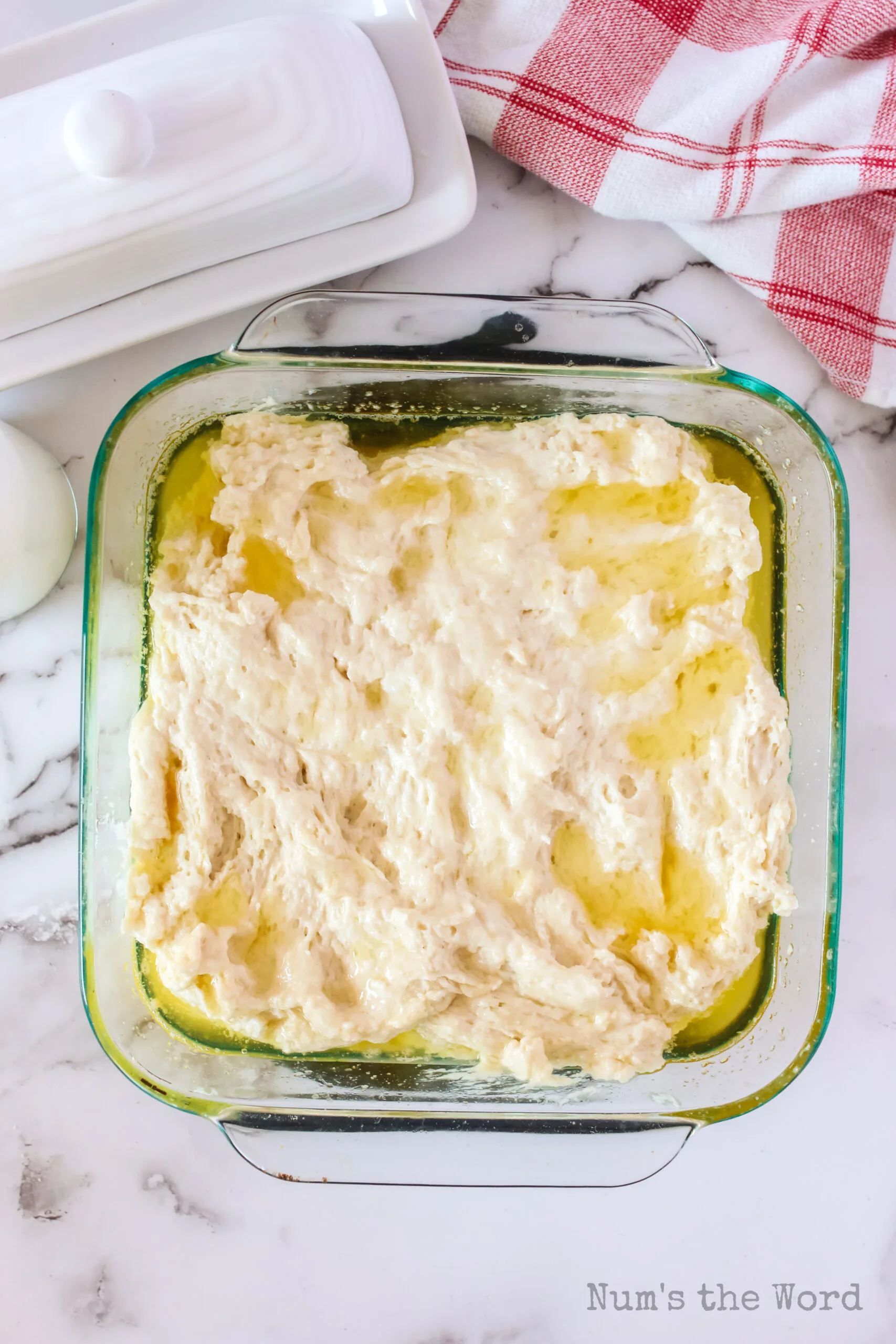 biscuit dough pressed into buttered casserole dish