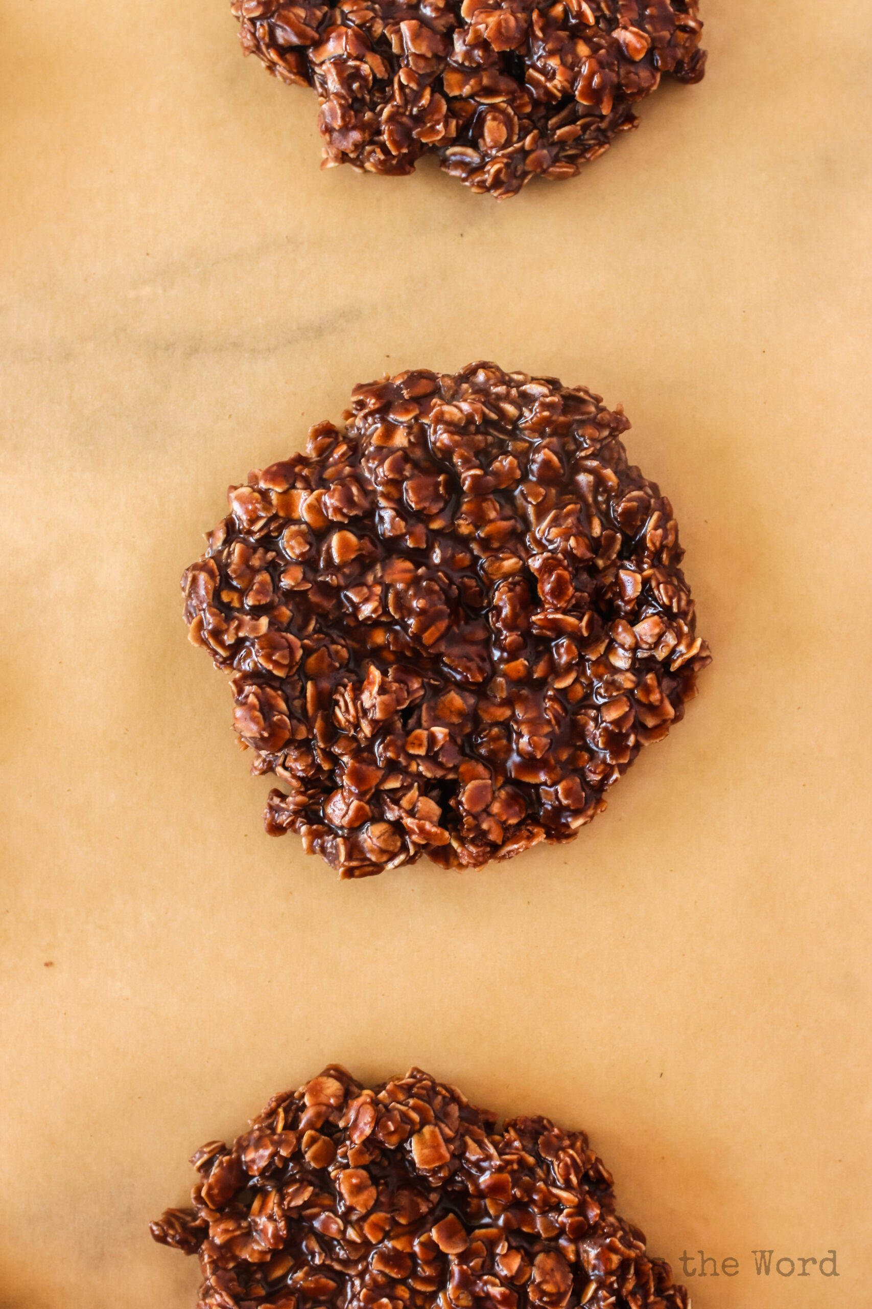 zoomed in image of 3 cookies on parchment paper