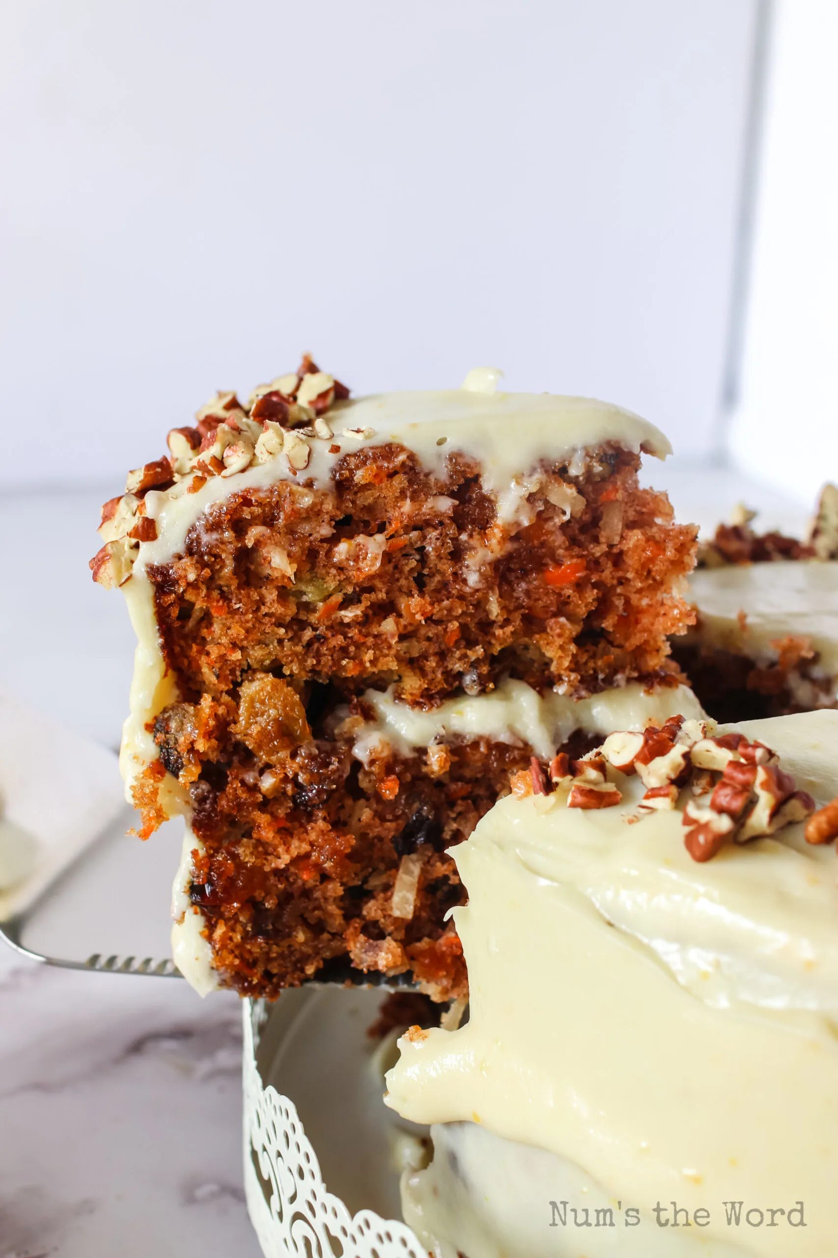 cut carrot cake with a piece being removed