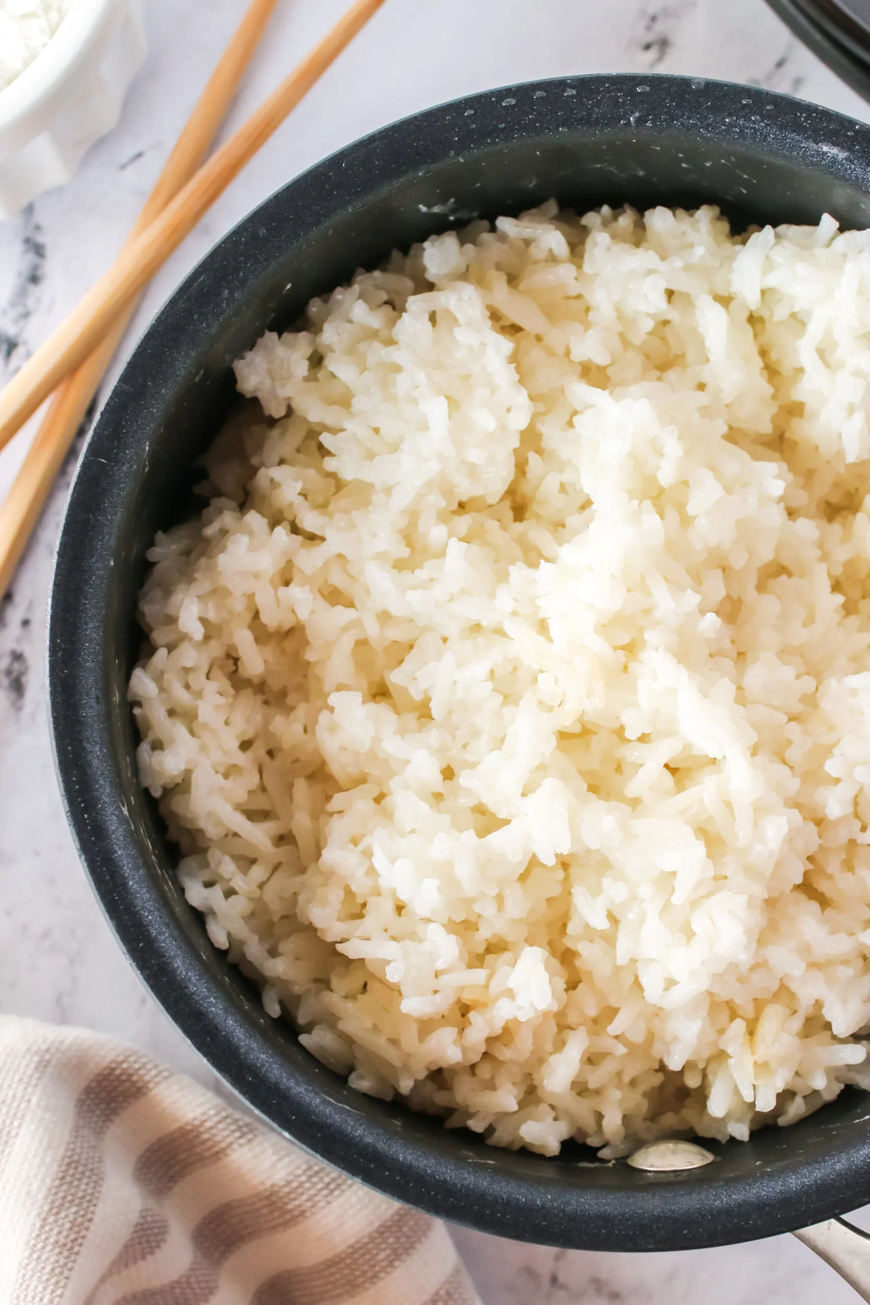 zoomed in image of fluffy rice in pot ready to serve