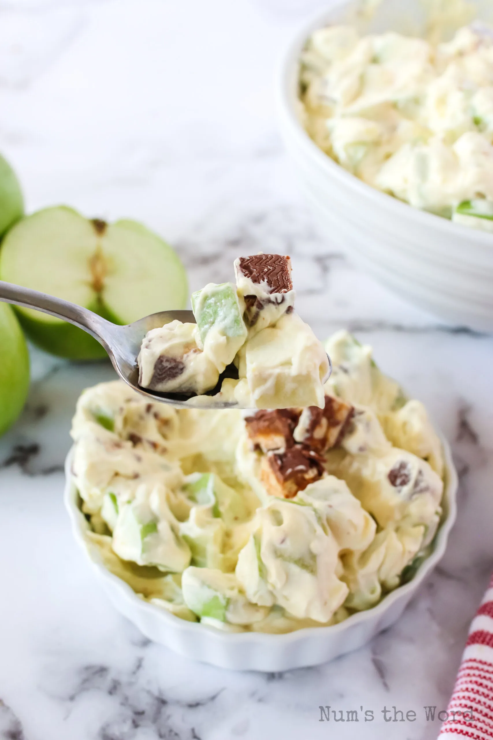 side view of spoon scooping out a bite sized portion of salad