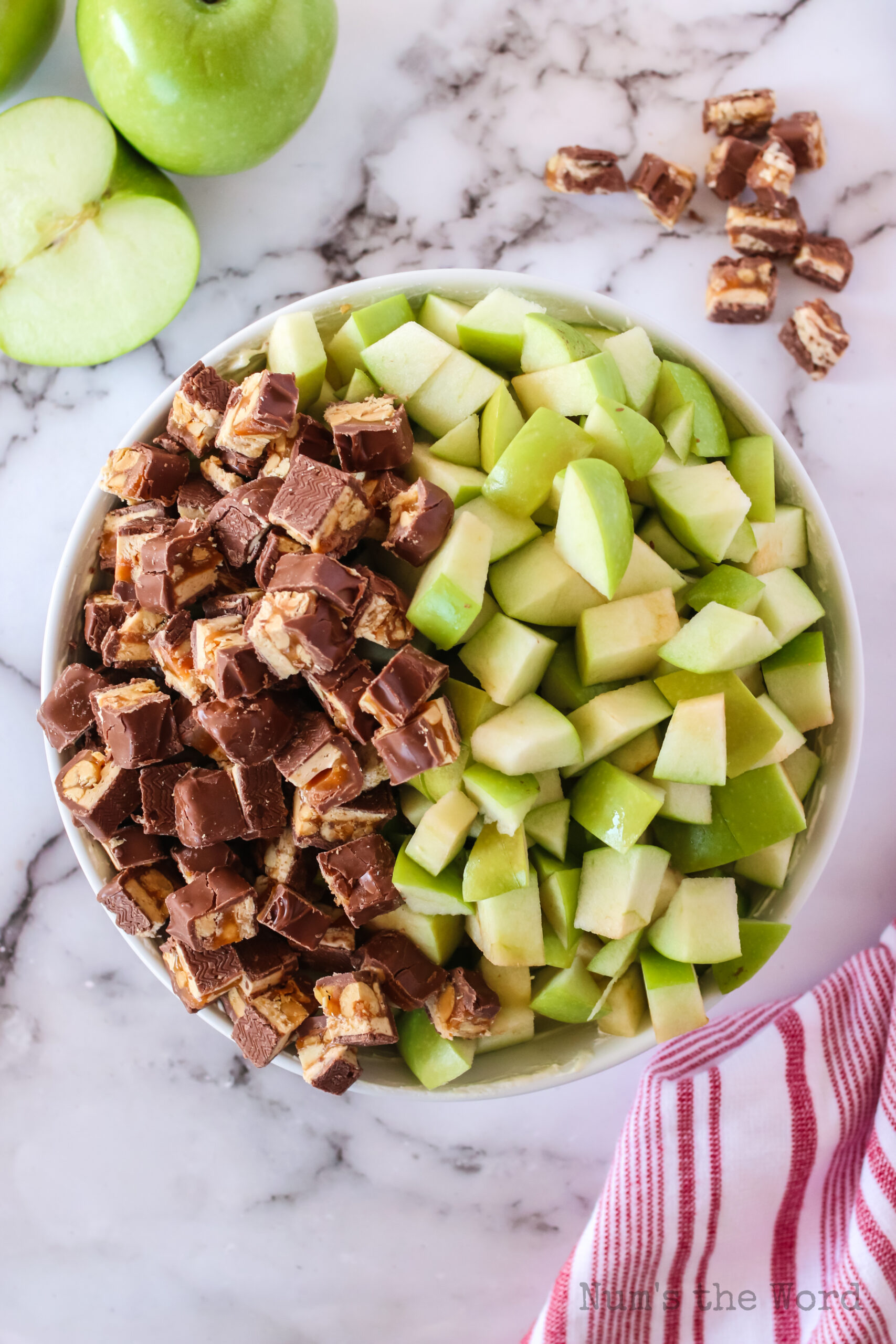 sliced apples and snickers added to jello mixture