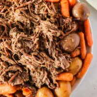 zoomed in image of pot roast with veggies all around
