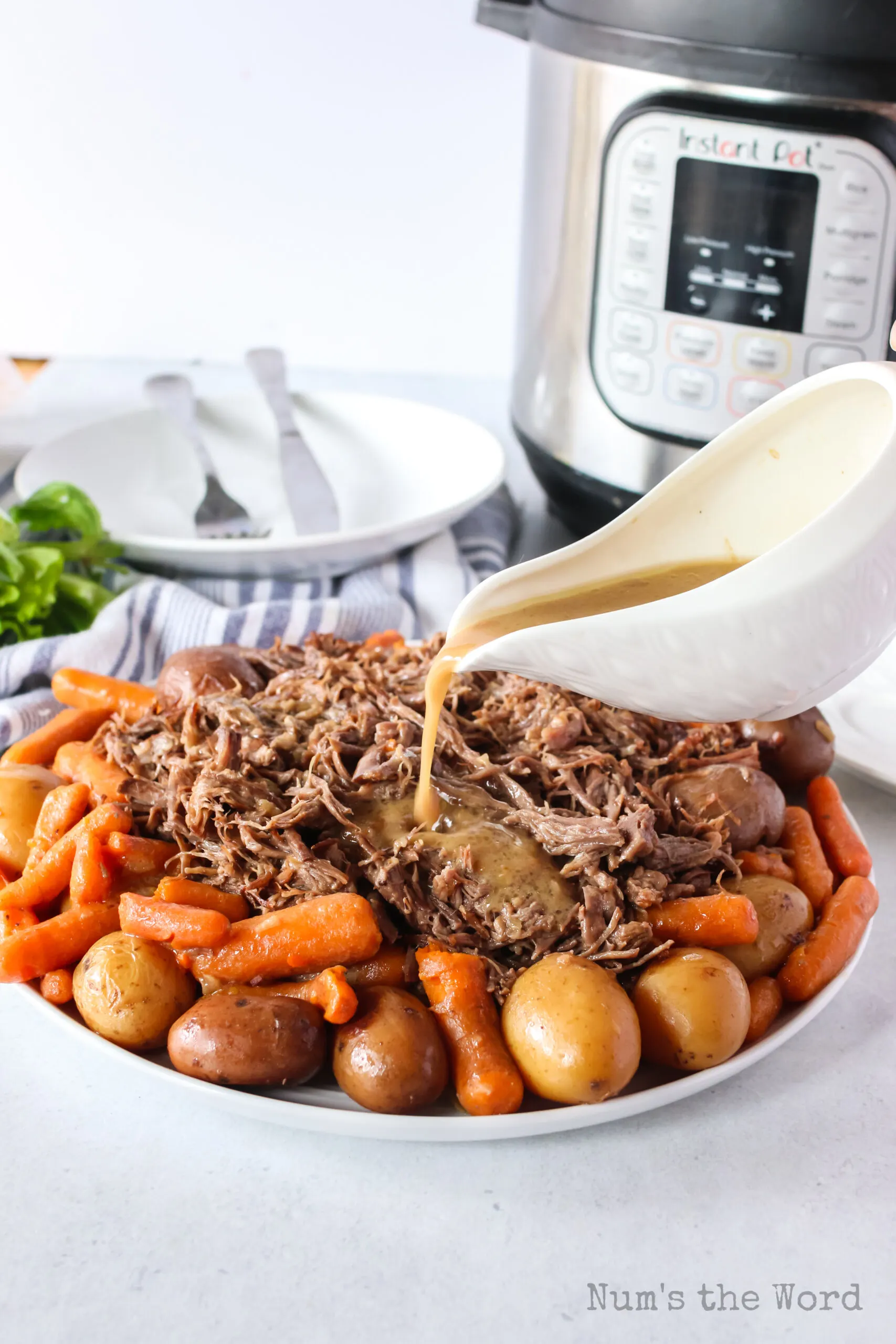 gravy poured over pot roast and veggies