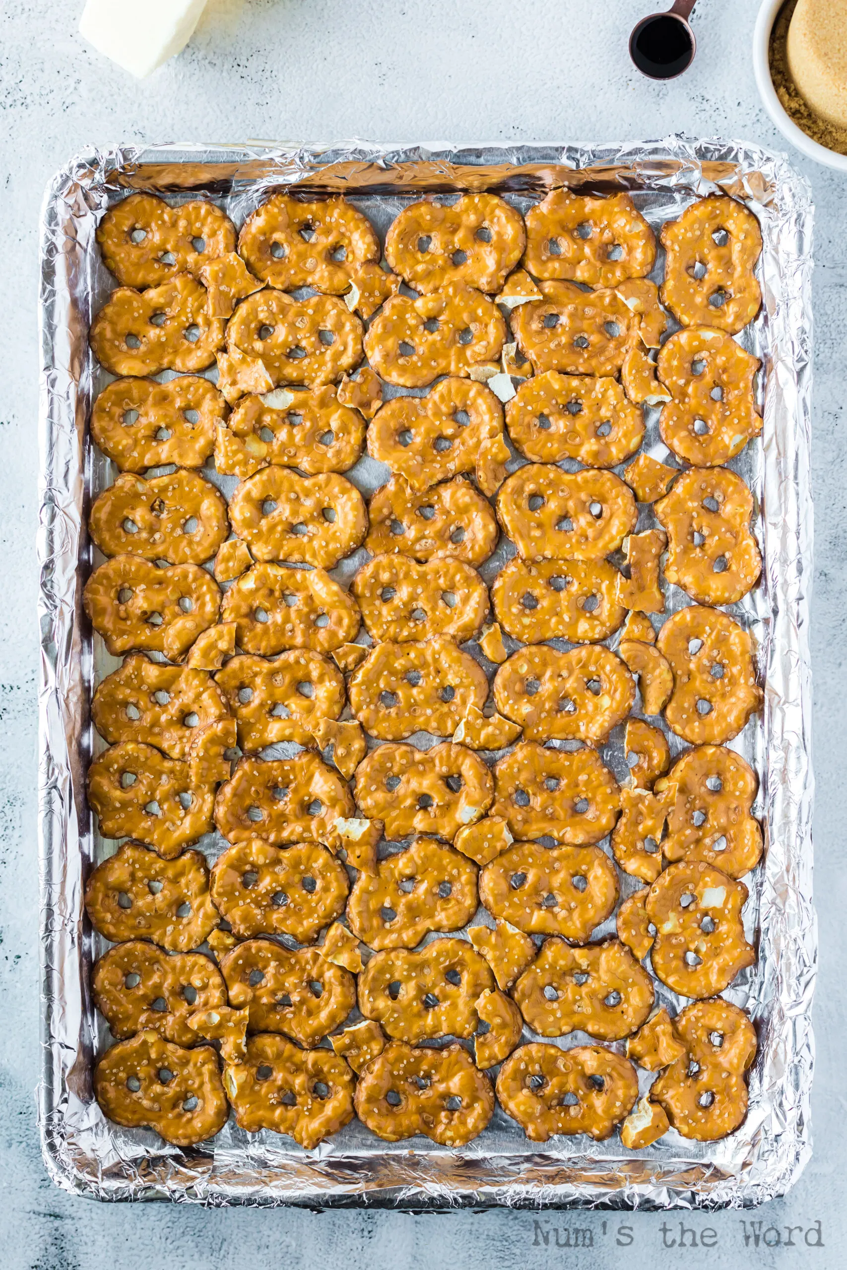 pretzel crisps laid out on cookie sheet