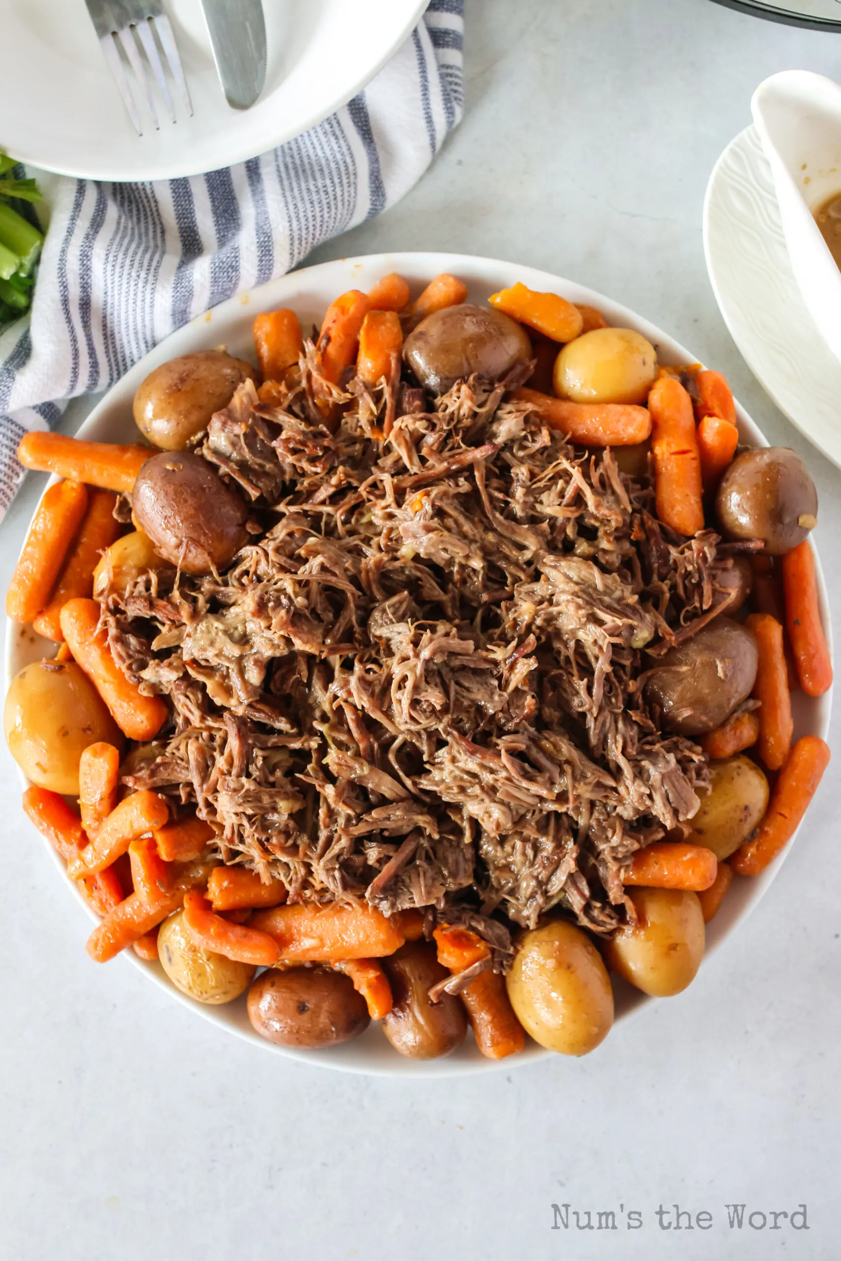 top view looking down of pot roast on a platter with veggies